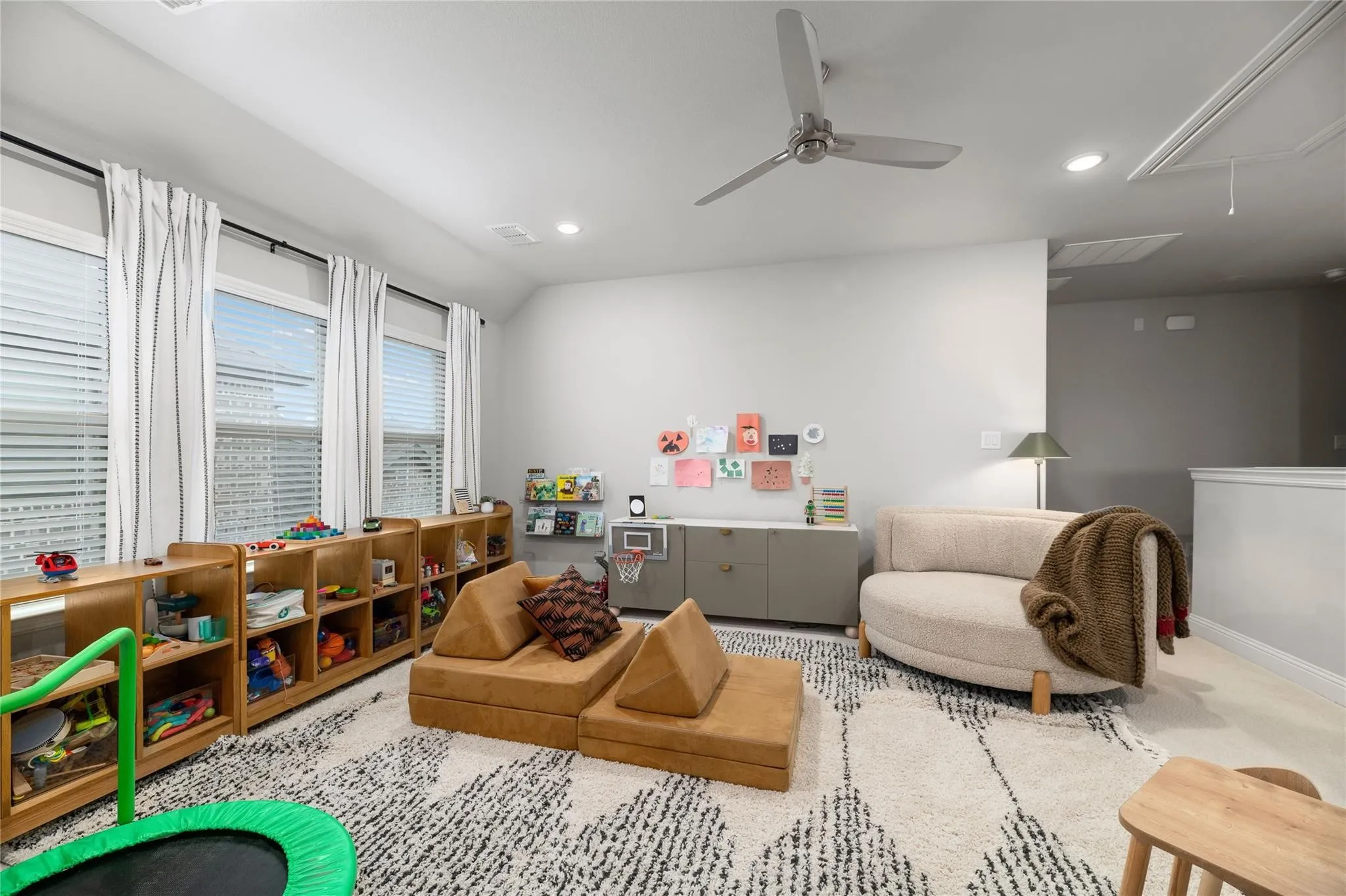 Recessed lighting, wood-finish shelving, multi-panel windows with blinds, a ceiling fan, and a built-in console