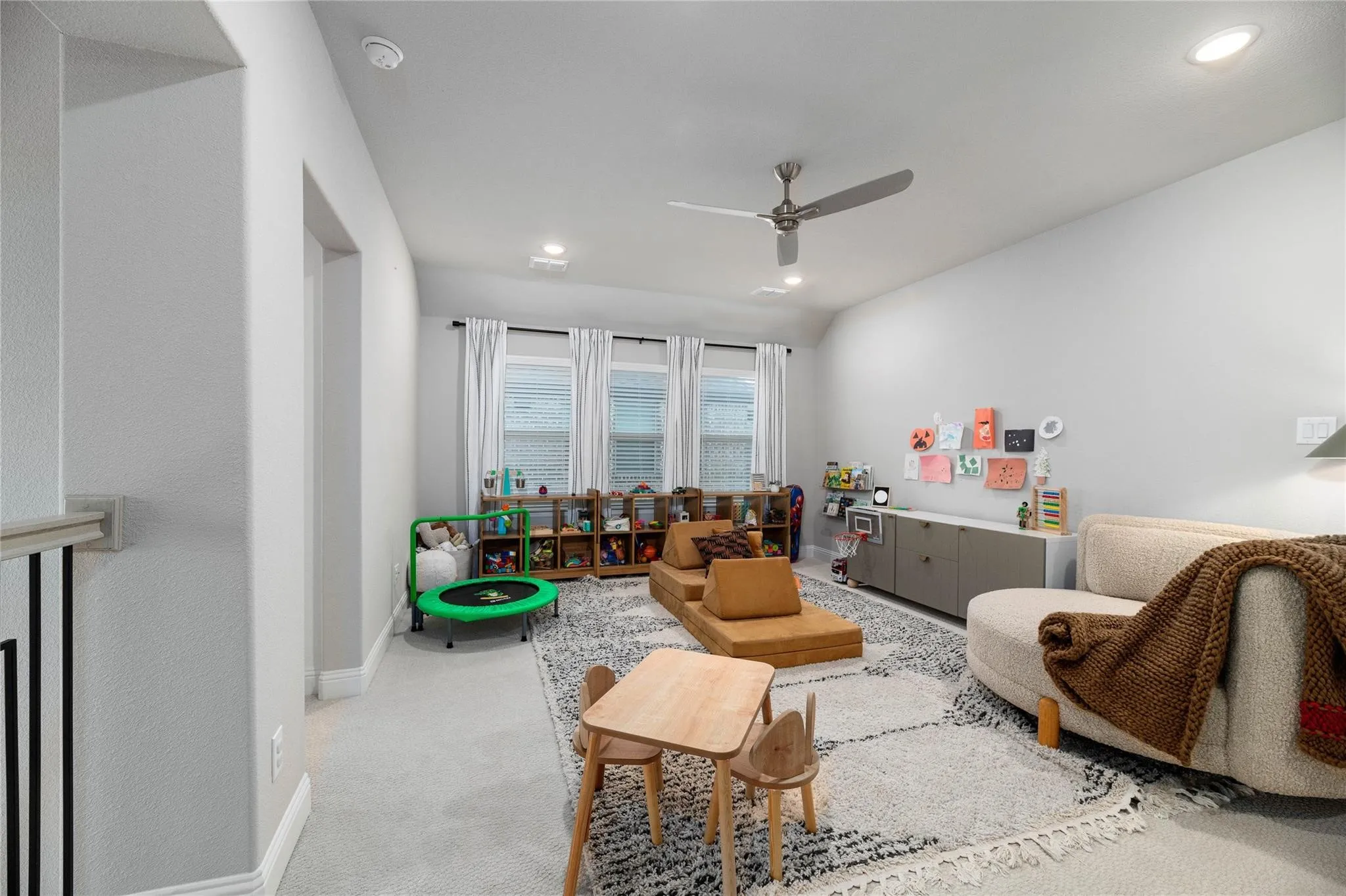 Spacious room featuring multiple windows, recessed lighting, a ceiling fan, and light-toned walls