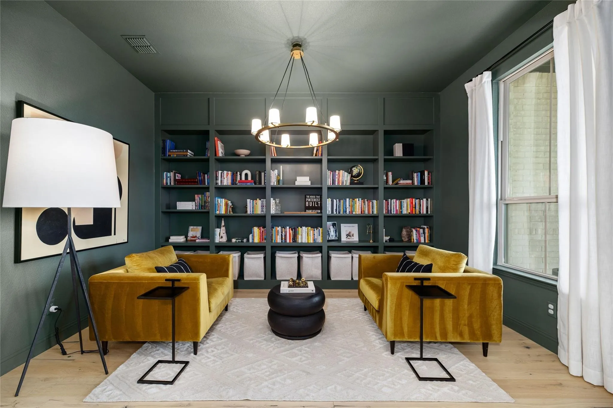 Built-in shelving, wood-finish flooring, recessed lighting, and a contemporary chandelier