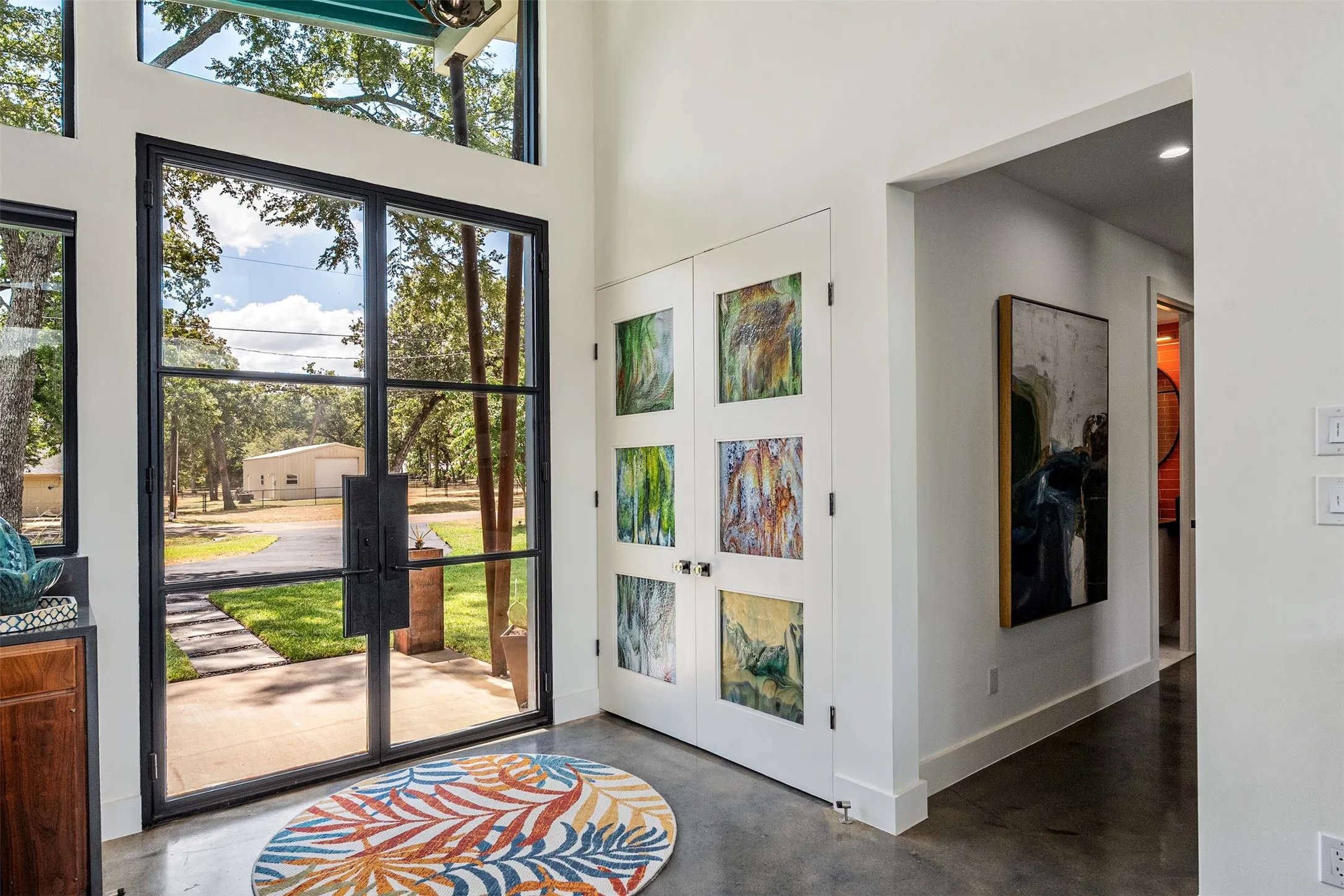 Double steel-framed glass doors, featuring dallas crafted "bullseye" stained glass