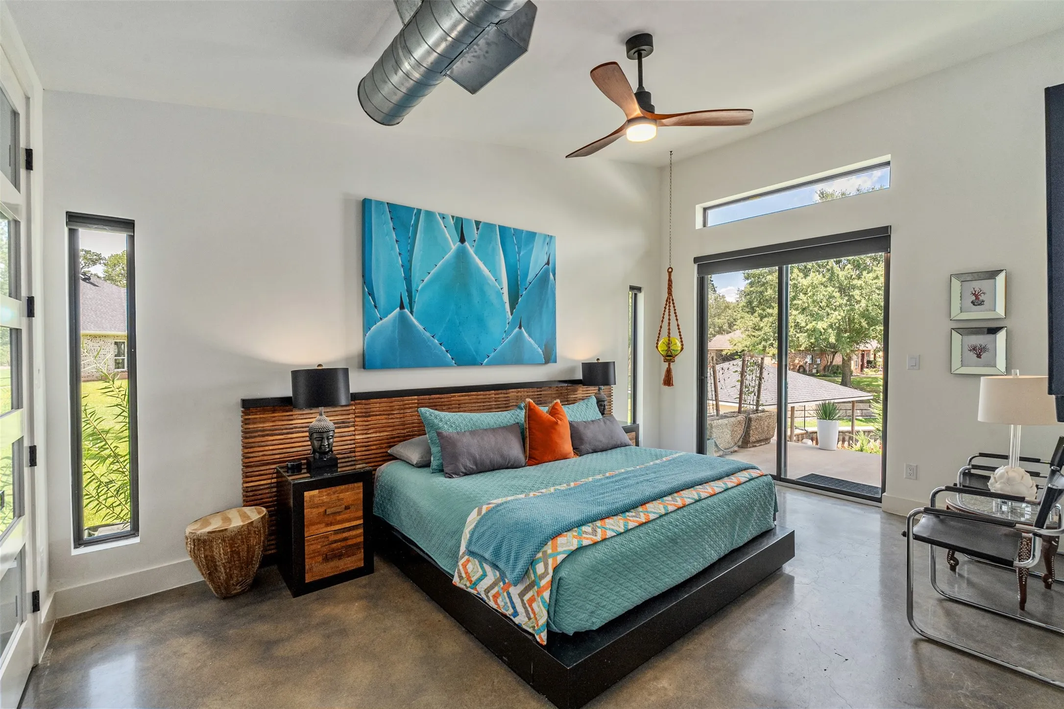 Primary en-suite bedroom with lake and pool views, custom closet, and sliding glass doors for ease-ability to backyard oasis.
