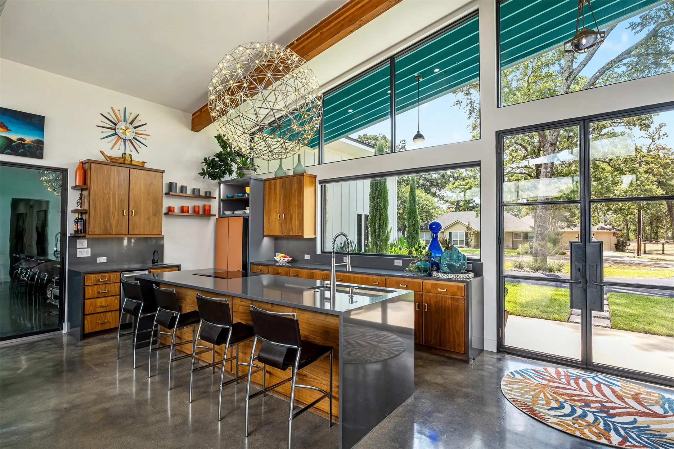 Bespoke kitchen appliances, reclaimed walnut cabinets, quartz waterfall island, and wet bar