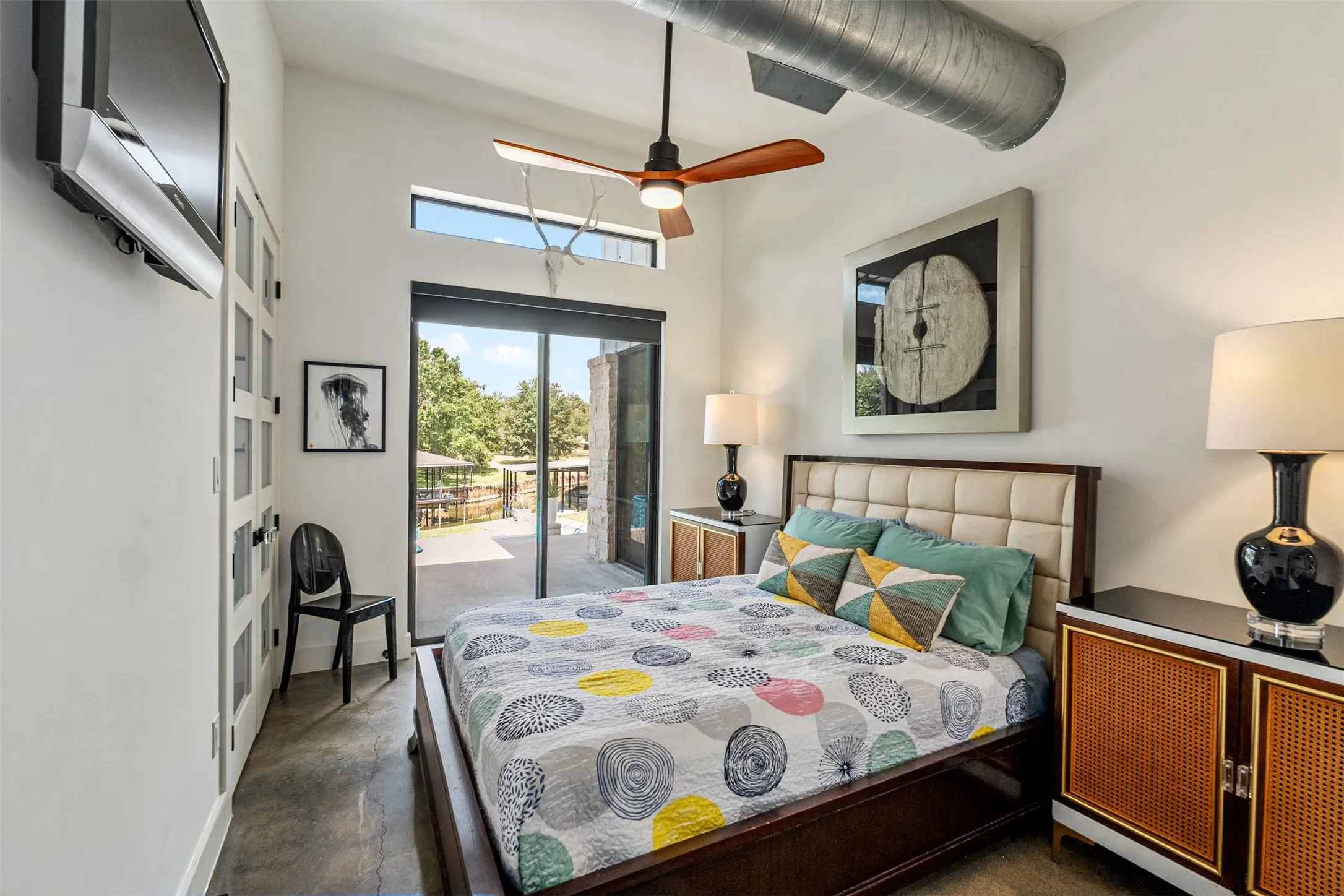 Bedroom 2 with lake and pool views. Sliding glass doors for ease-ability to the water