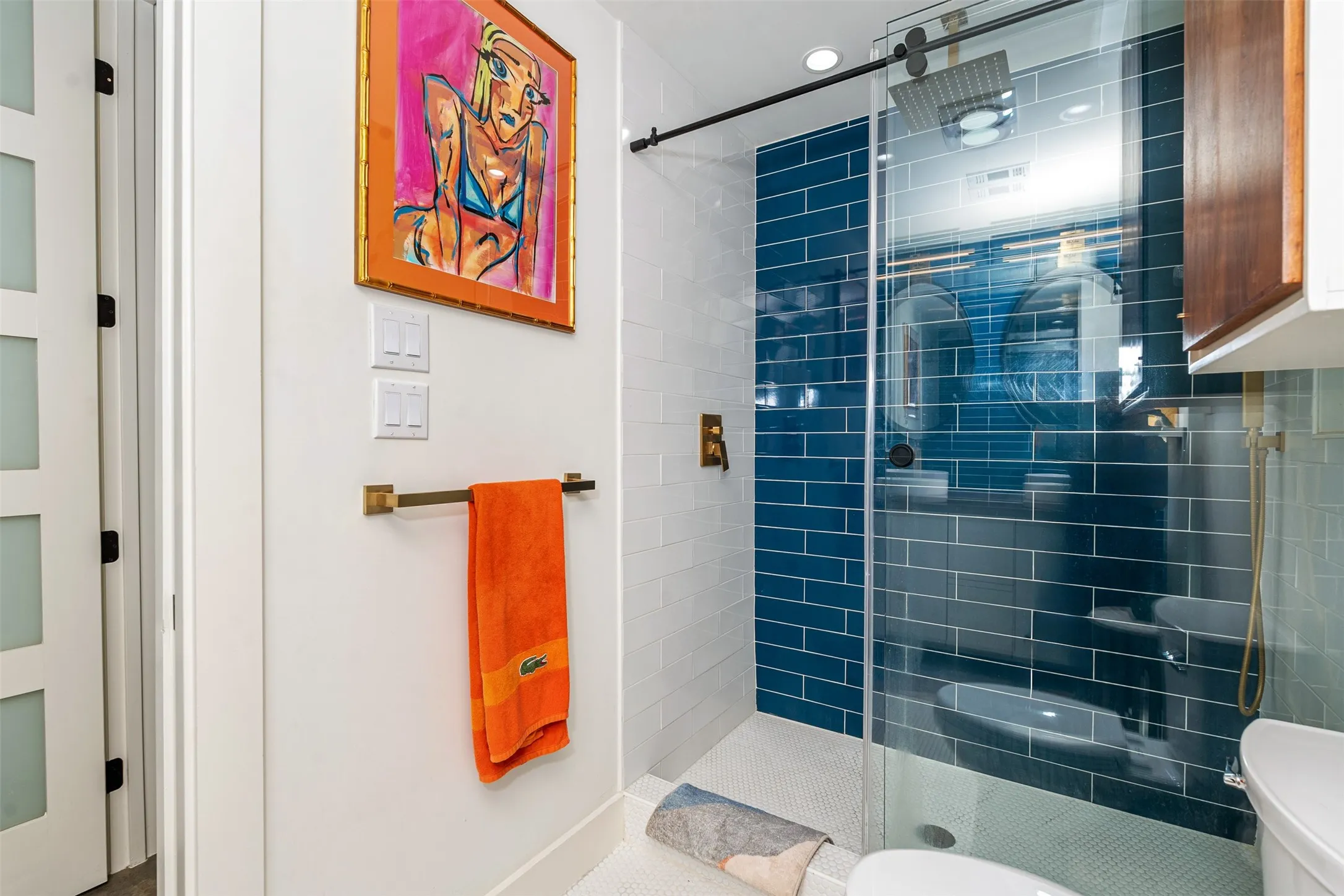 Primary en-suite shower, sliding glass door, and floor to ceiling tile.