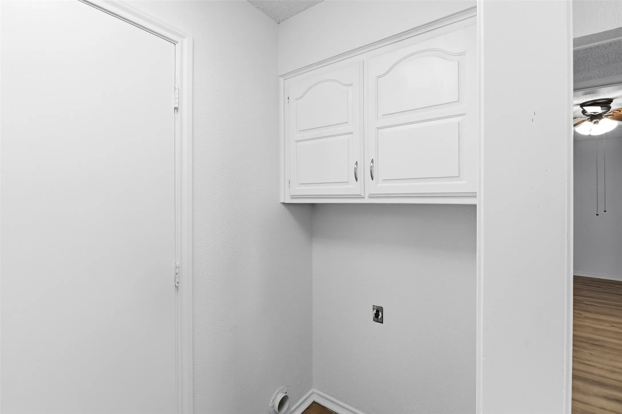 The laundry room has built-in cabinets