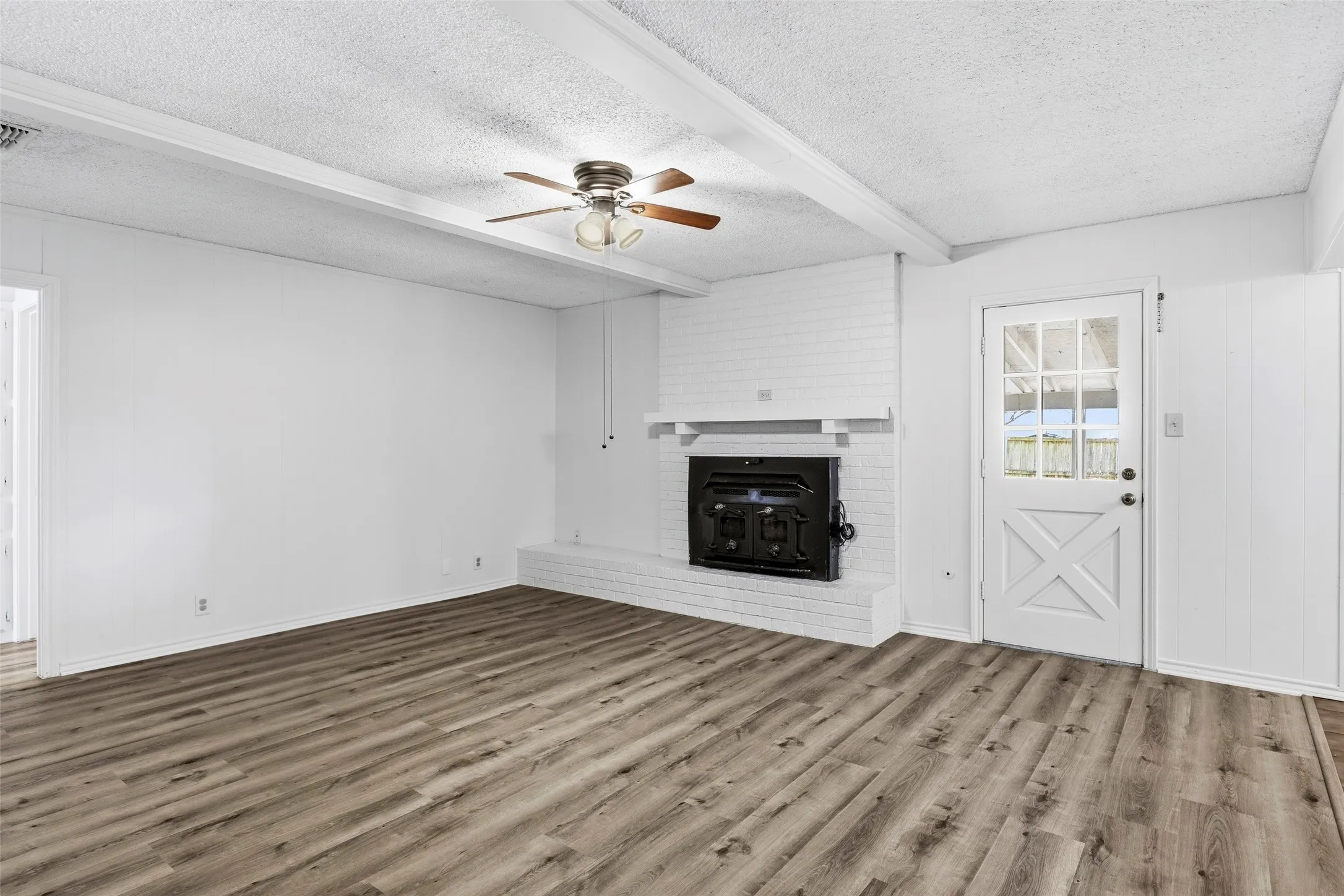 Large living room with pretty brick fireplace