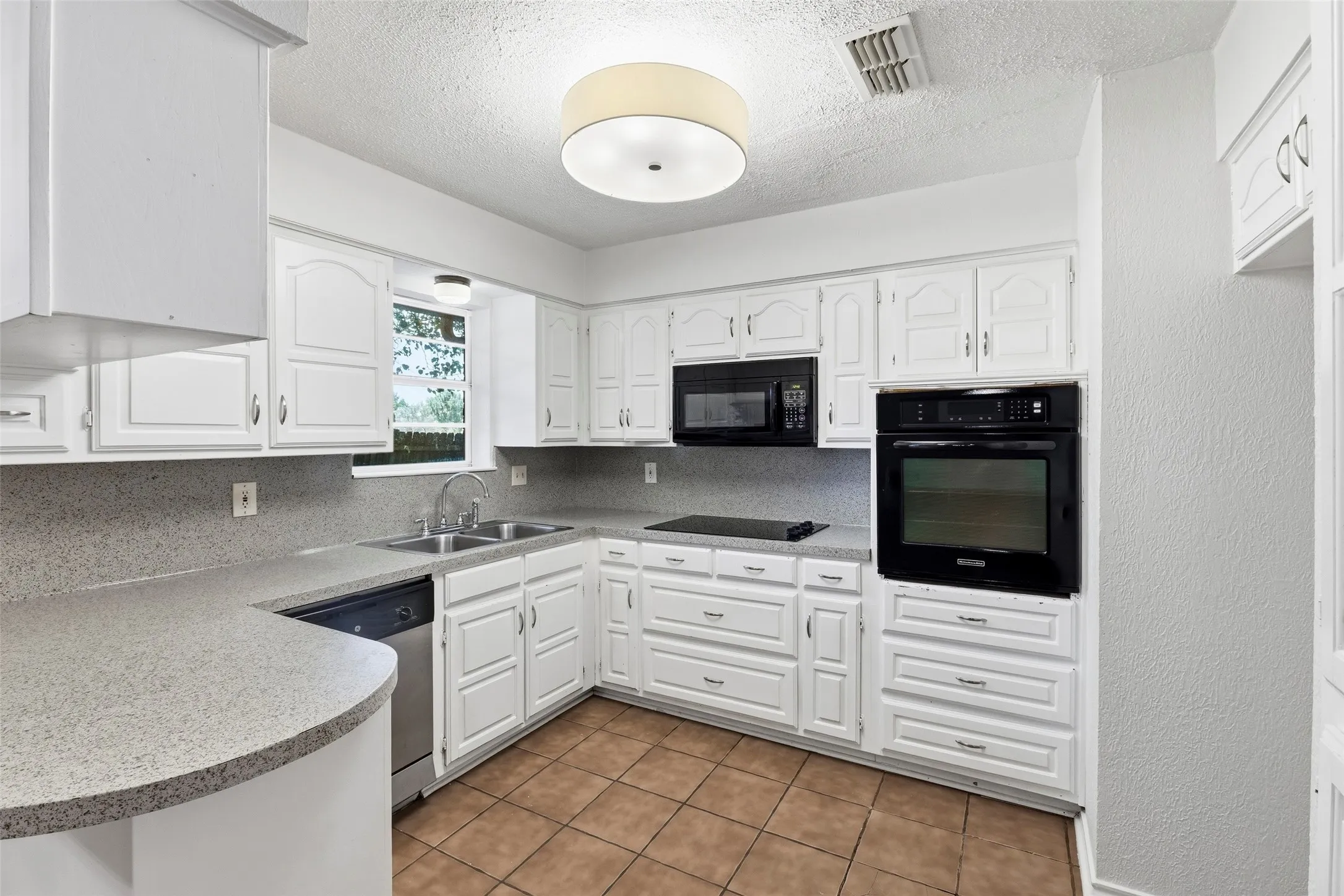 Pretty kitchen with wall oven, electric cooktop, built-in microwave, and so many cabinets