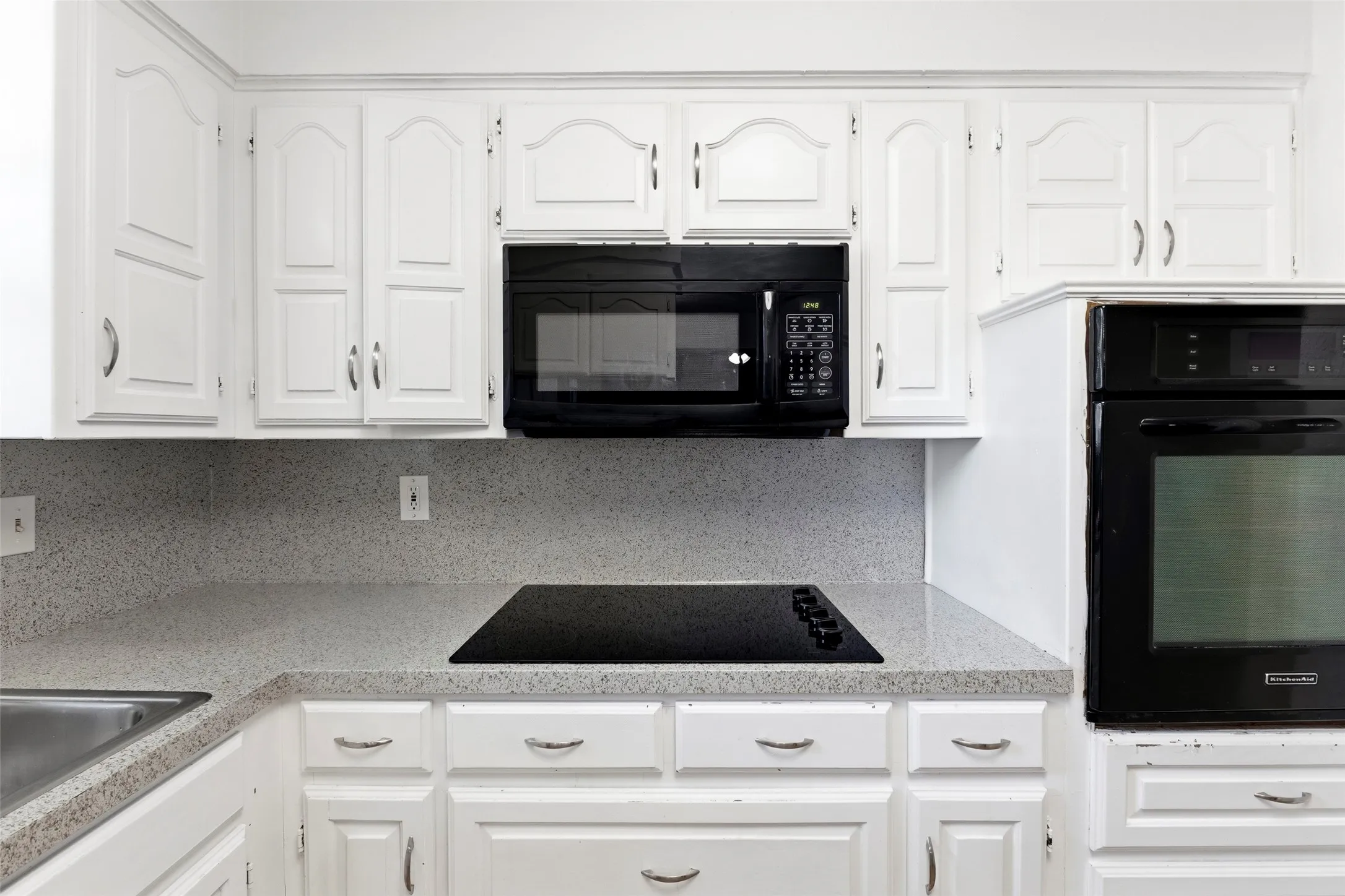 Pretty kitchen with wall oven, electric cooktop, built-in microwave, and so many cabinets
