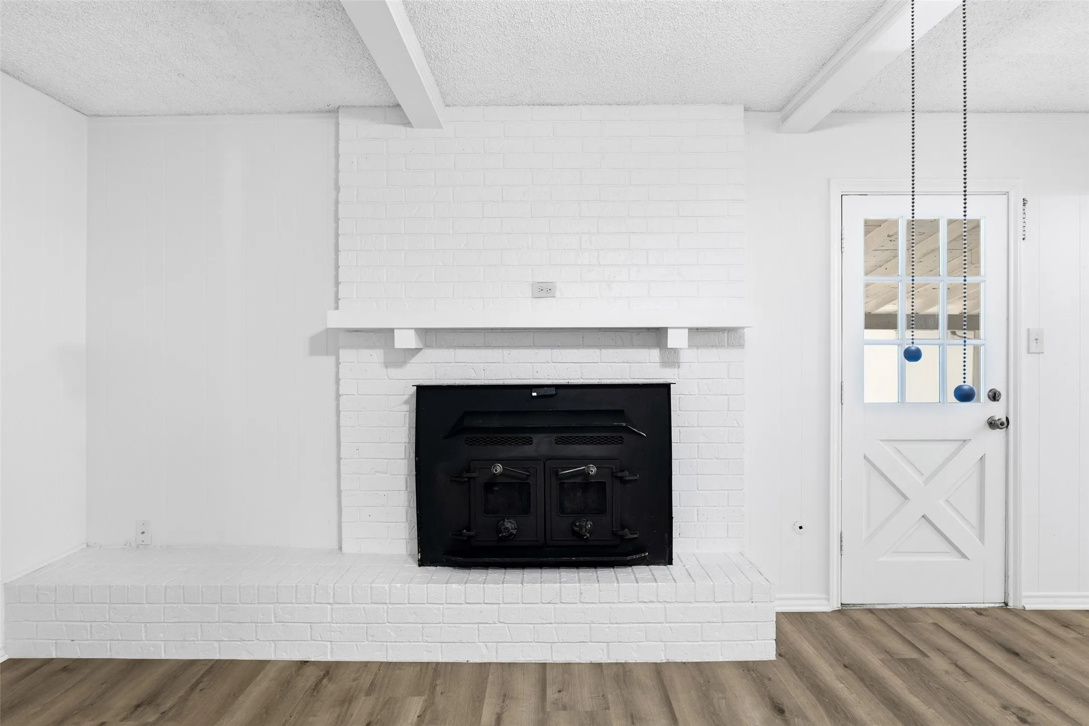 Large living room with pretty brick fireplace