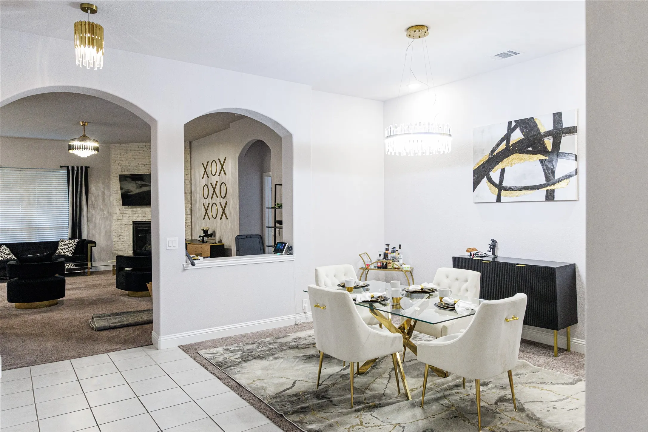 Archways defining entryways, white tile flooring, recessed lighting, and a crystal chandelier