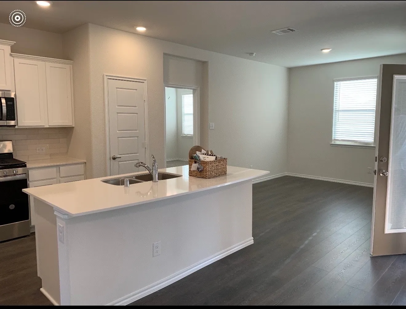 Kitchen island with an undermount double-basin sink and a light-toned countertop