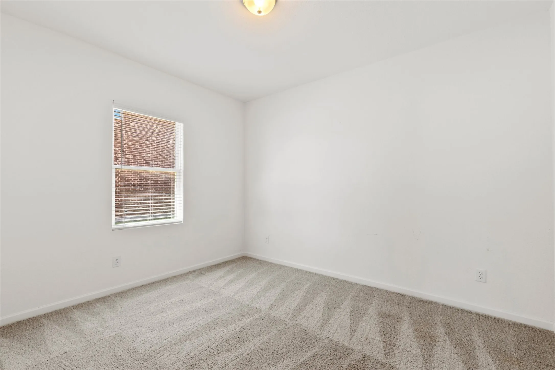 Secondary bedroom that could also make a great home office, gym or playroom.