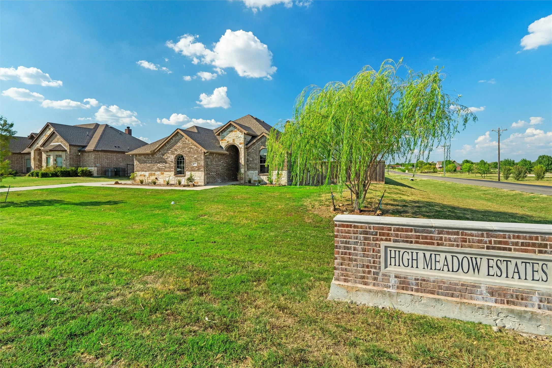 Brick and stone exterior featuring an arched entry and arched windows