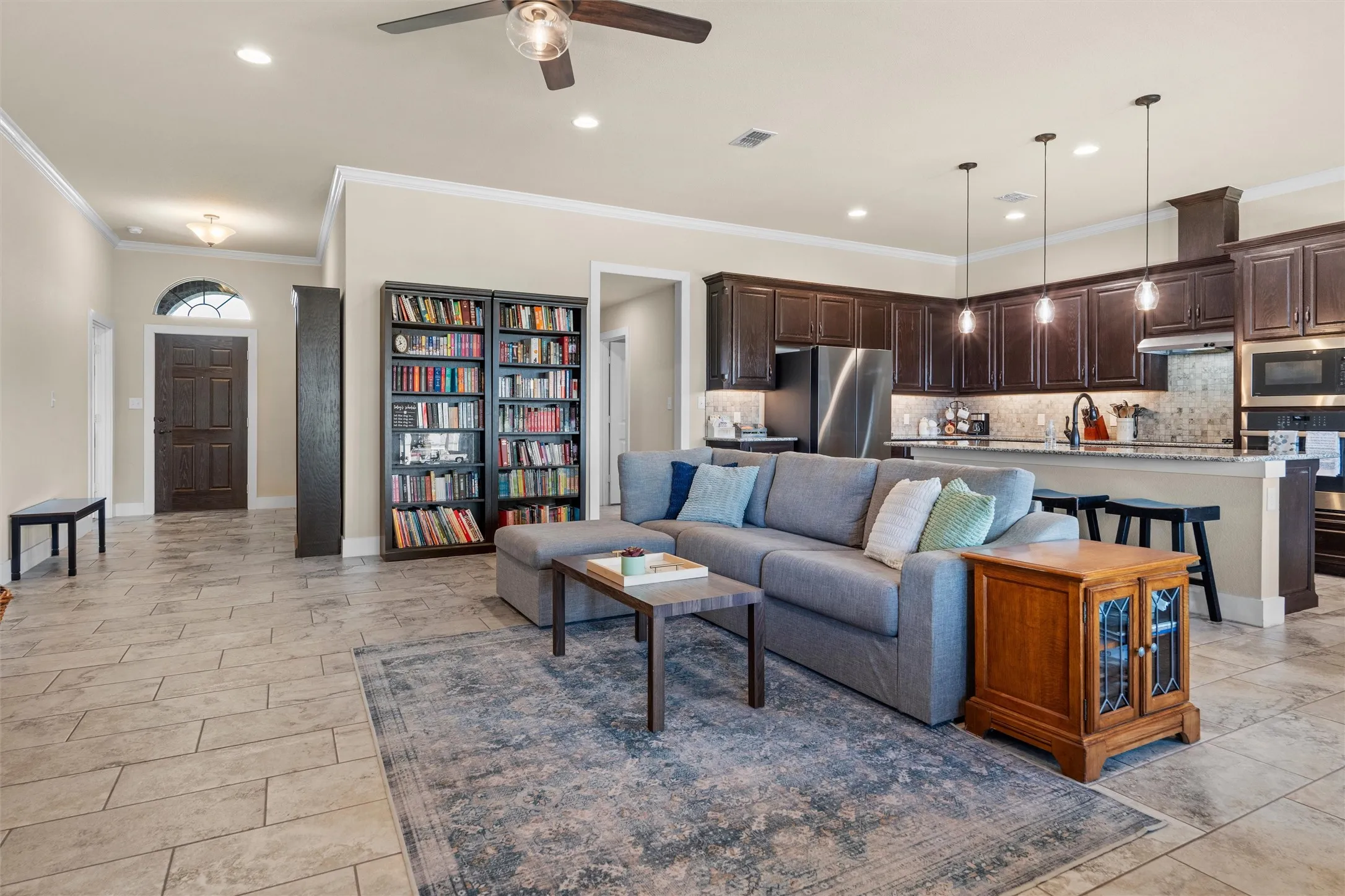 Open-concept living space featuring tile flooring, recessed lighting, and a ceiling fan