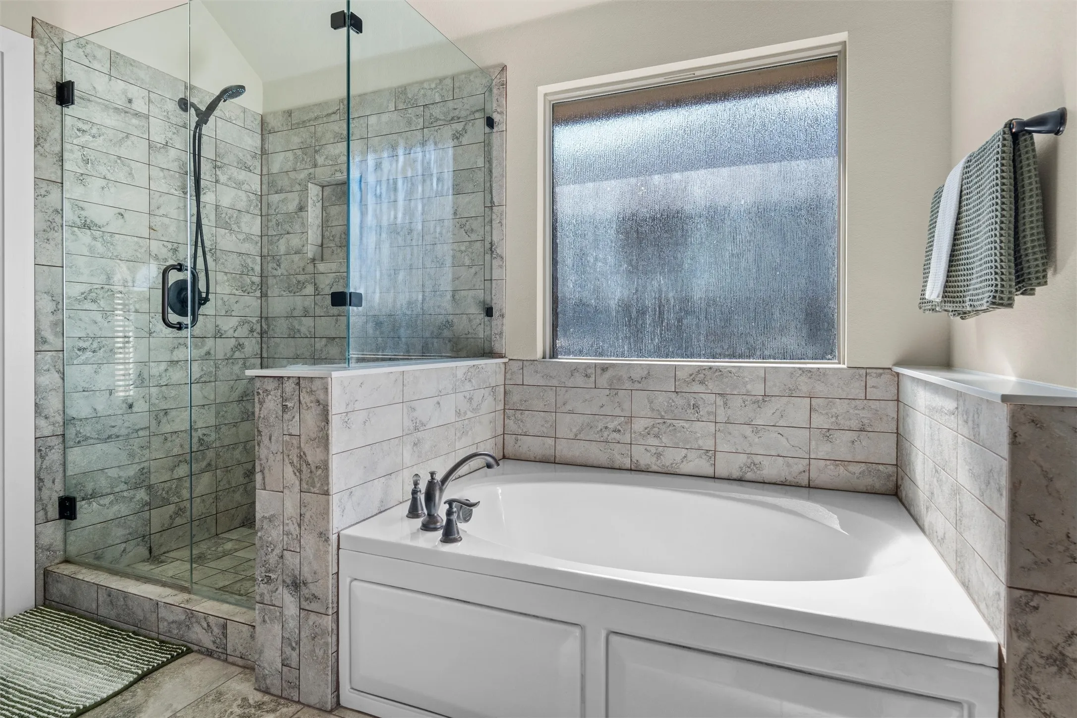 Freestanding shower with glass enclosure and black fixtures