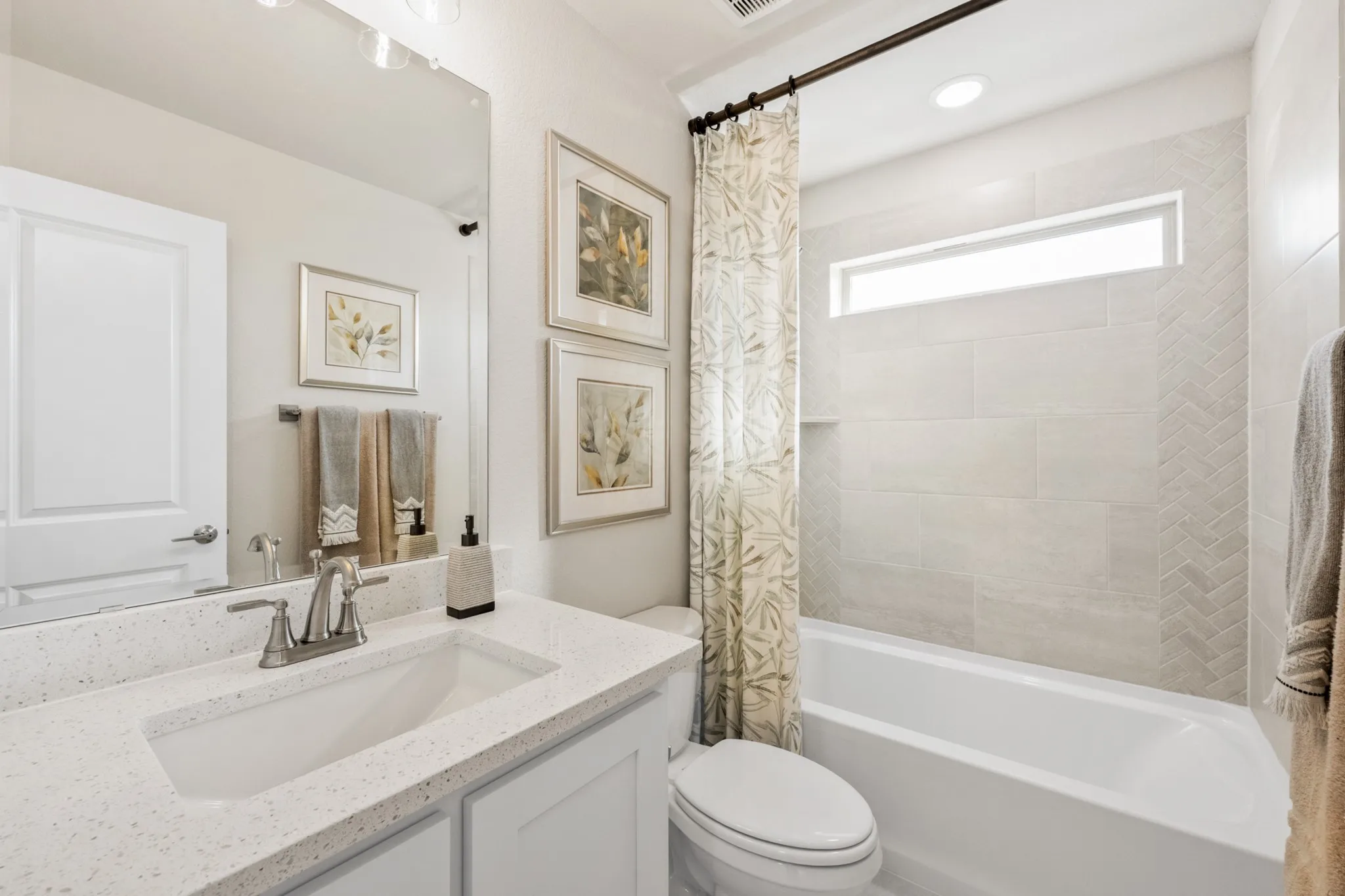 Built-in bathtub with subway tile surround and herringbone accent