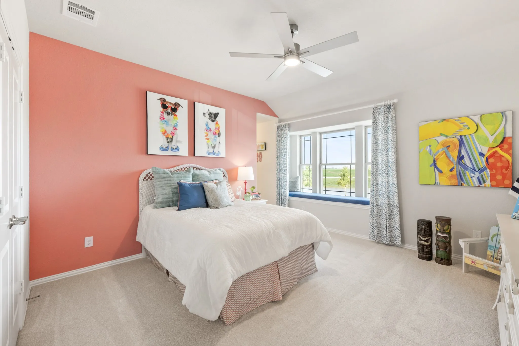 Recessed bay window with an integrated bench, neutral carpet flooring, and a ceiling fan with integrated lighting