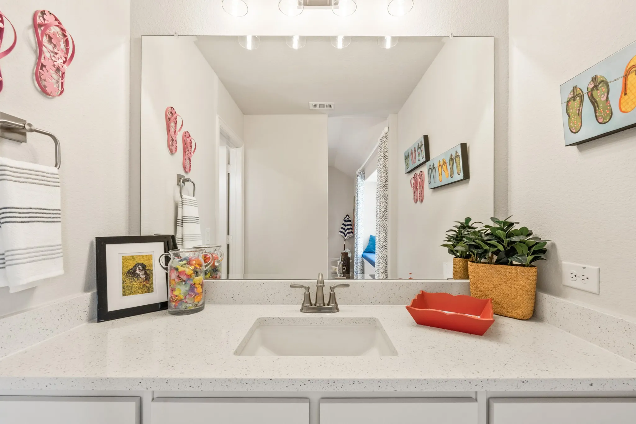 White vanity with integrated rectangular sink and a single-handle faucet