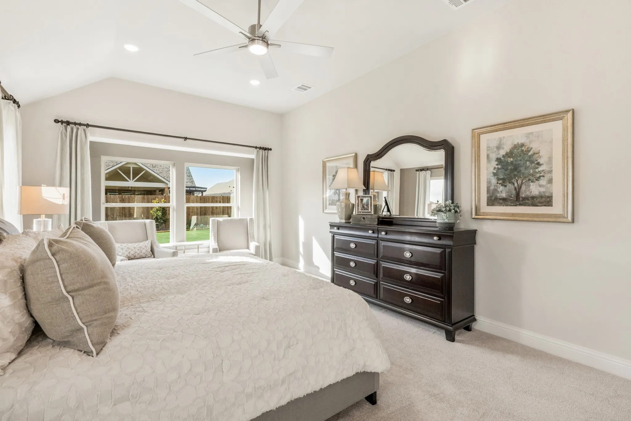 Vaulted ceiling with a ceiling fan, recessed lighting, double windows, and light-toned carpeting
