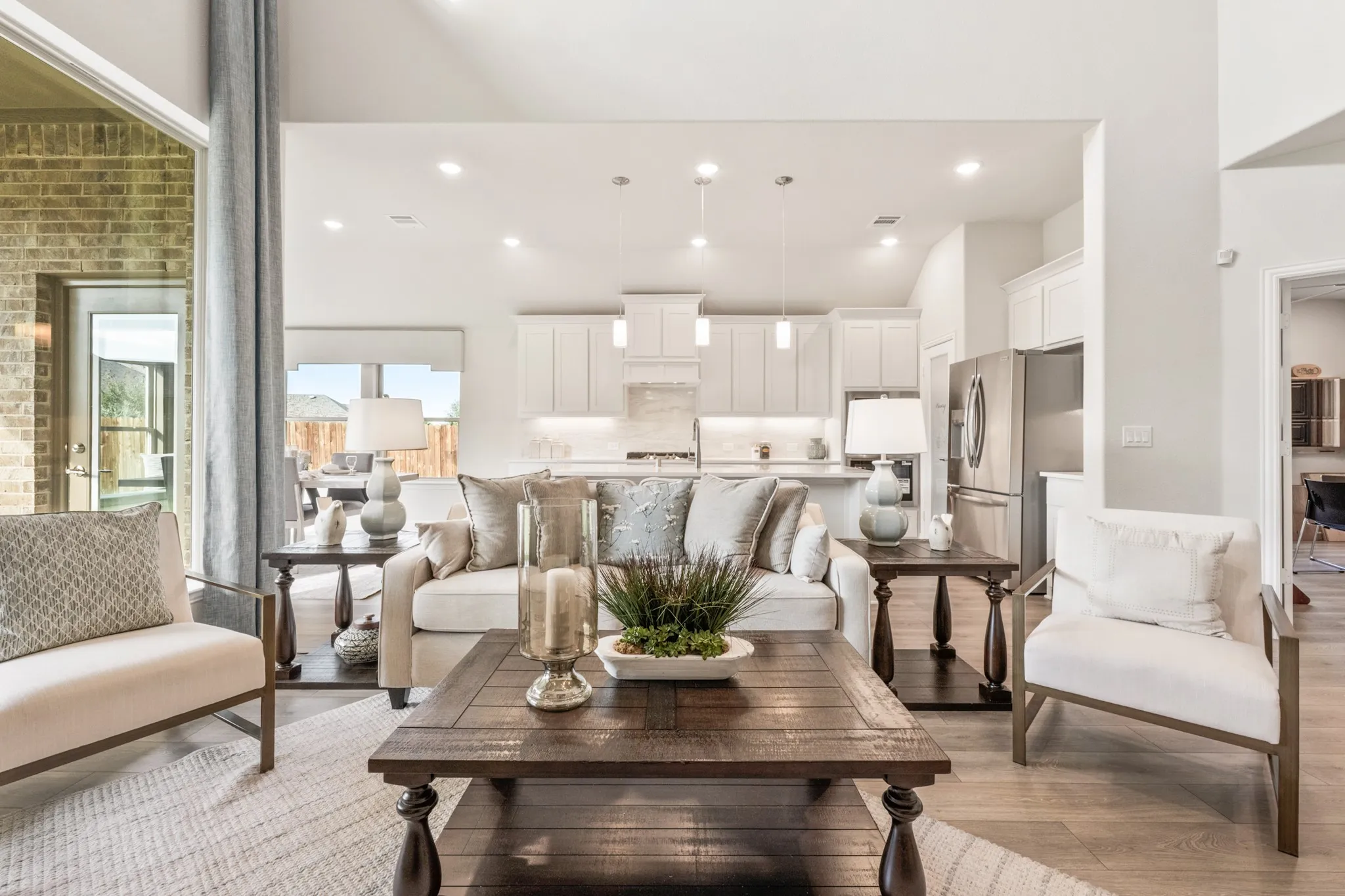 Open-concept living space featuring wood-finish flooring, recessed lighting, and a vaulted ceiling