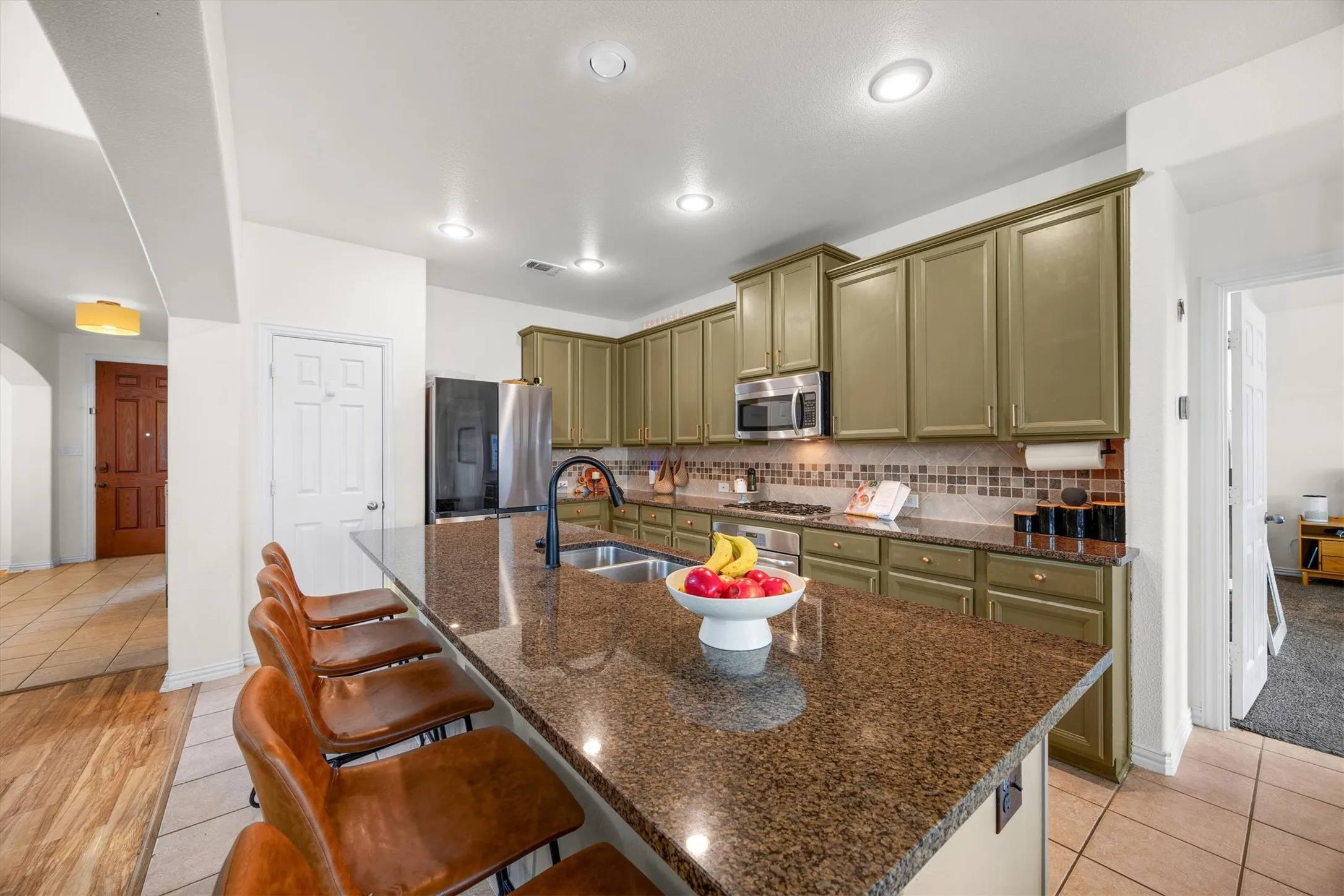 A large island centers the kitchen and overlooks the family room.