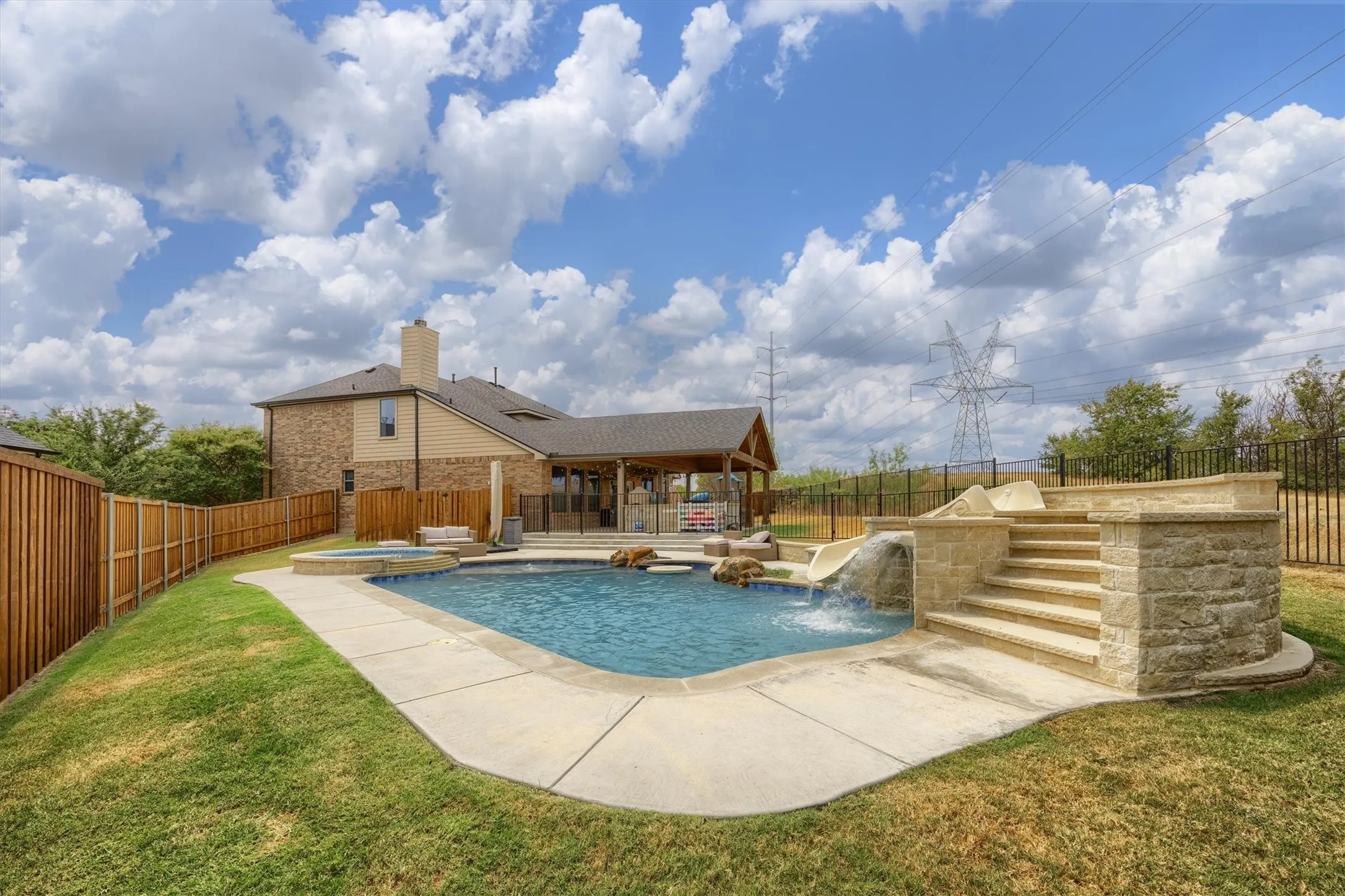 Child protective fence with gate separates the pool from the patio.