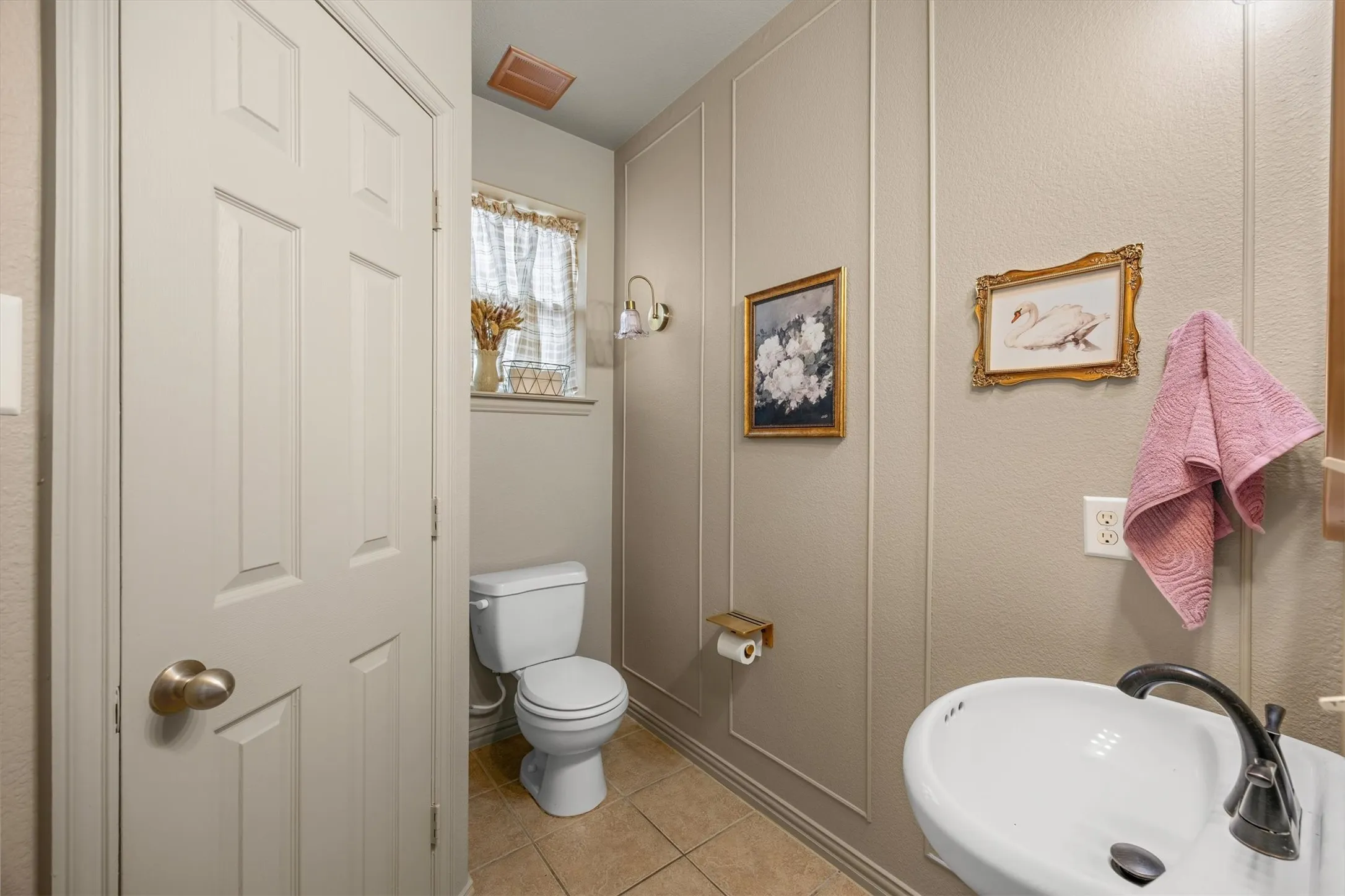 The powder bath is situated in the center of the home for easy access from any downstairs room.