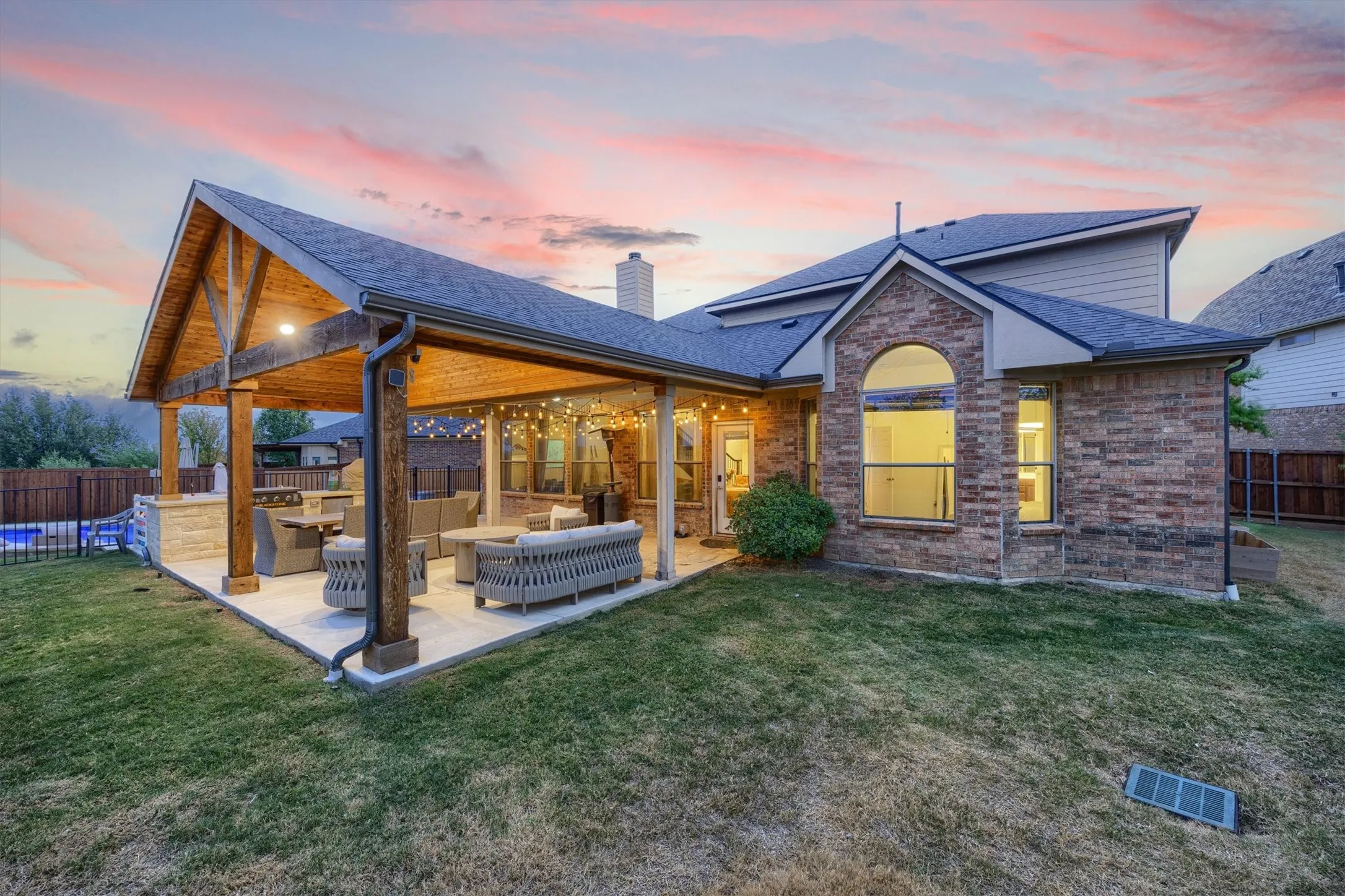 The backyard offers an incredible patio with a built in Blackstone!