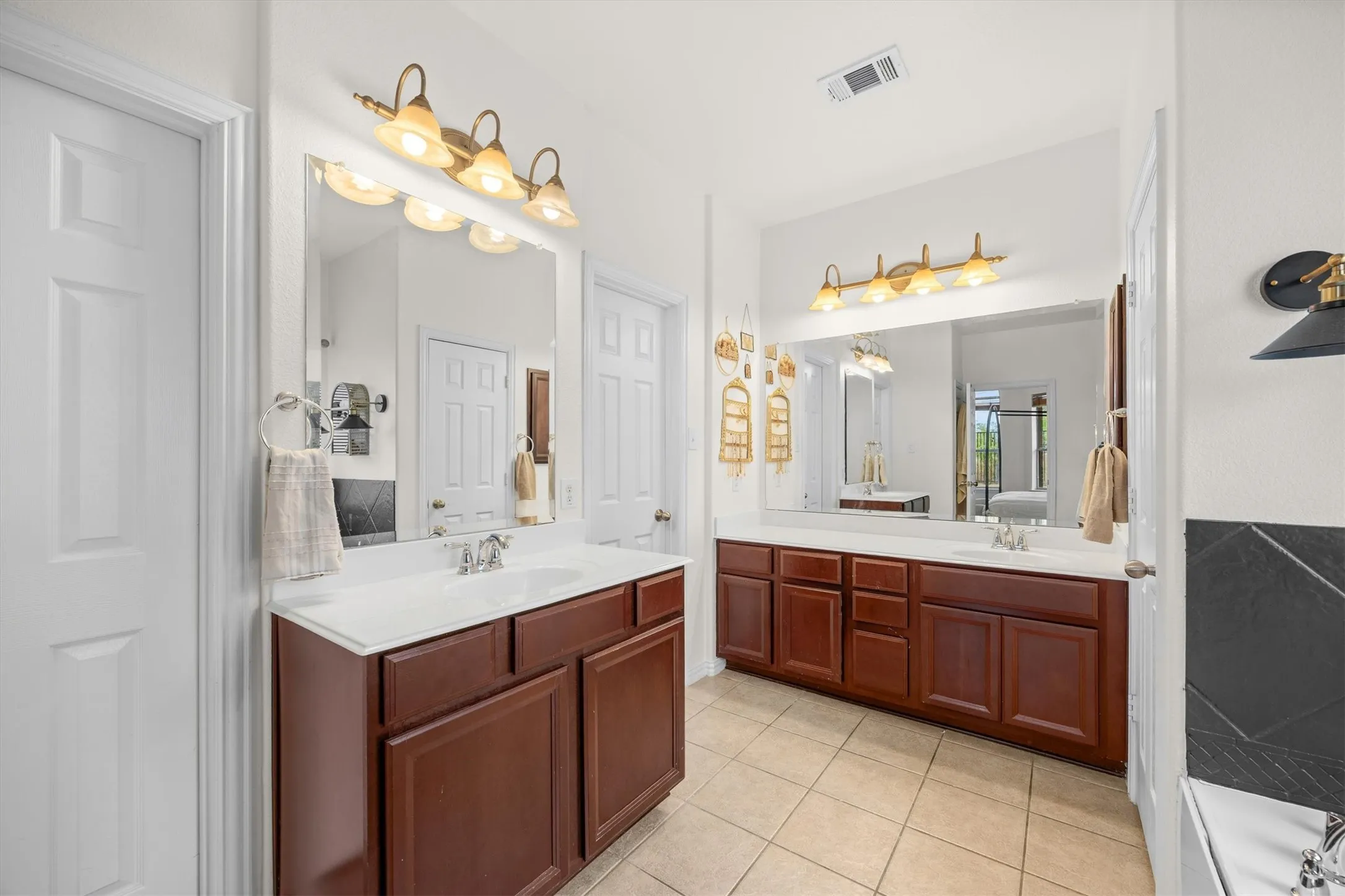 Two sinks adorn the primary bathroom.