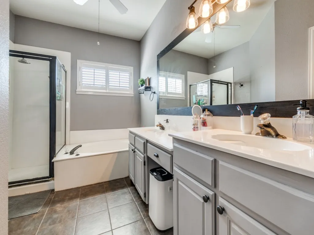 Dual vanity with white countertops, undermount sinks, and gray cabinetry