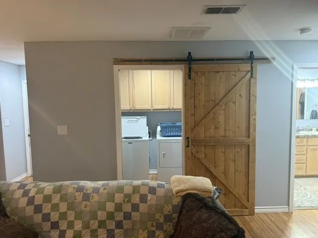Barndominium - Laundry room with barn door entry.