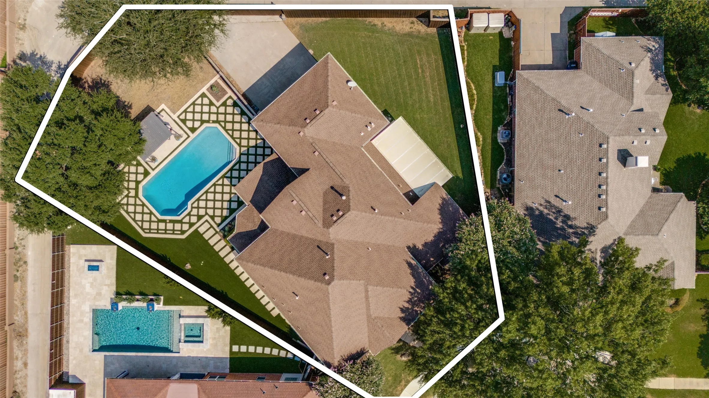 Brown shingle roofing, expansive backyard, mature trees, and a rectangular swimming pool with surrounding hardscaping