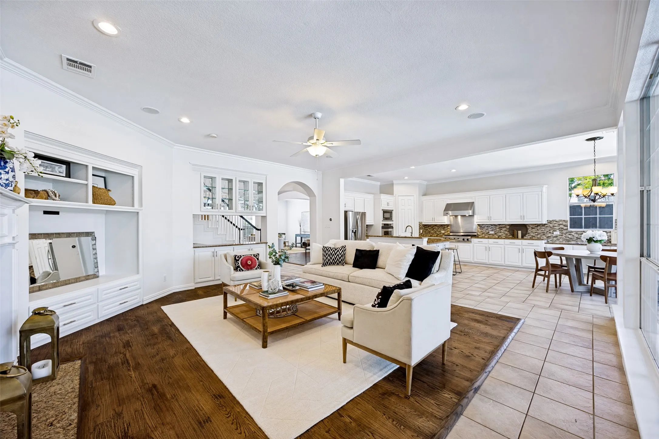 Expansive living area featuring wood-finish flooring, recessed lighting, and a built-in entertainment center