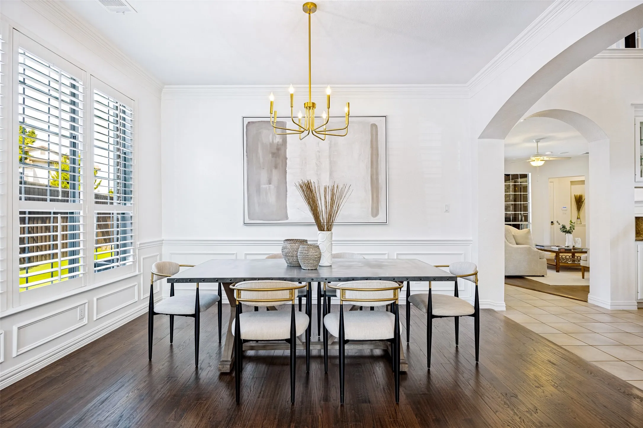 Rich wood-finish flooring with white wainscoting