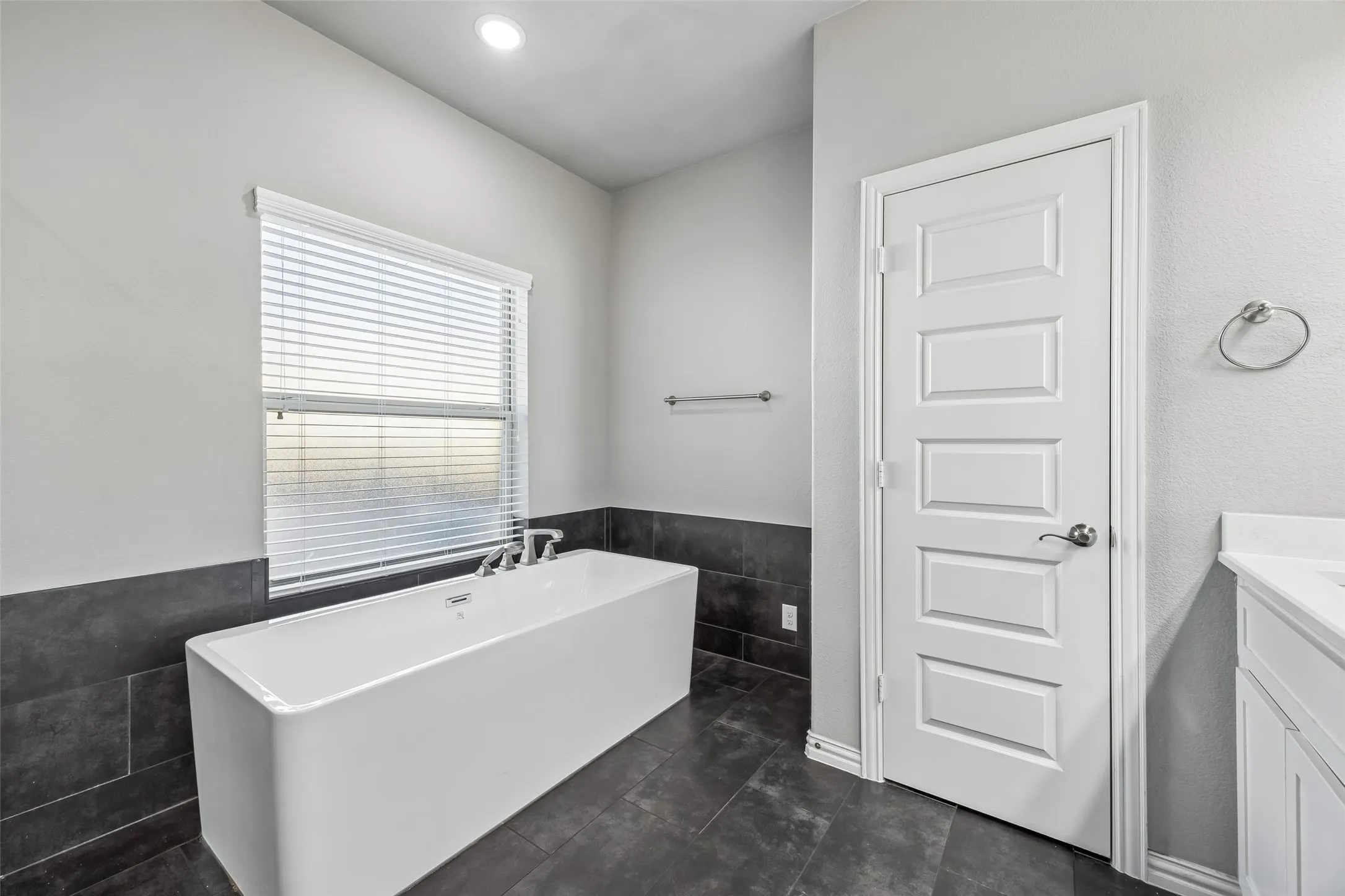Primary bathroom with a double head shower and a rain shower, double sinks, soaking tub and quartz marble countertops.