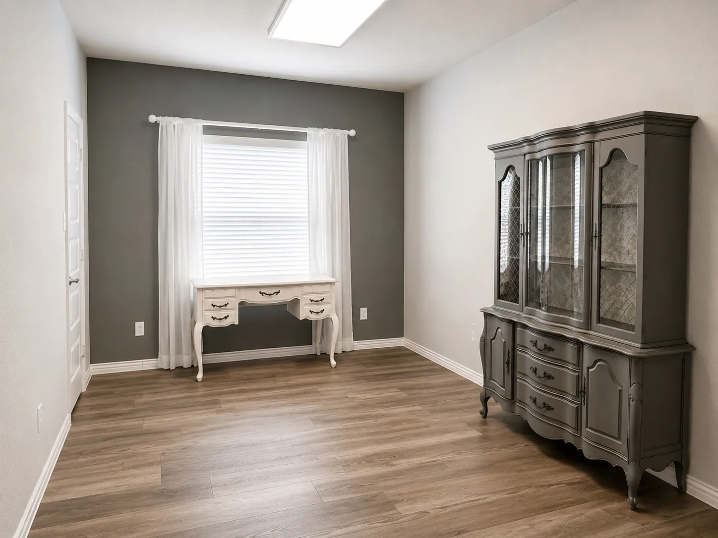 Bedroom 2 downstairs with LVP flooring and closet.