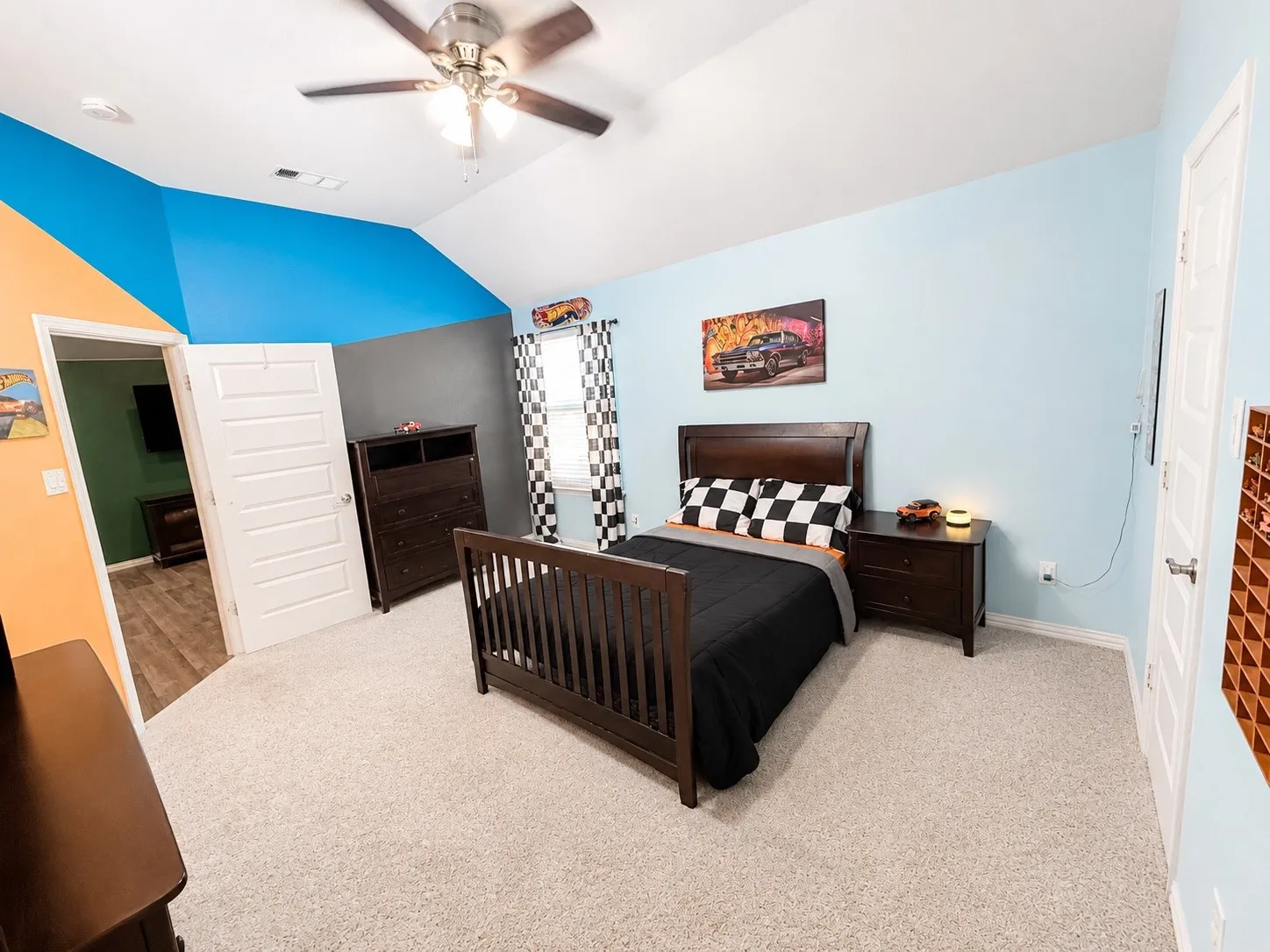 Bedroom 6 with a ceiling fan, carpet and walk in closet.