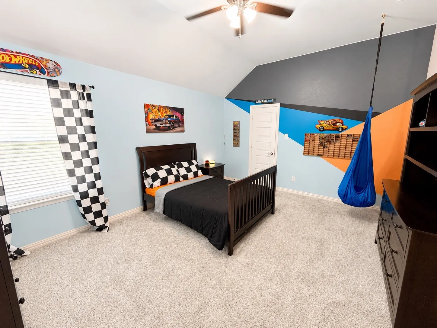 Bedroom 6 with a ceiling fan, carpet and walk in closet.
