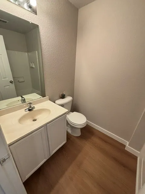 Contemporary bathroom featuring a white vanity with an integrated sink, chrome faucet, and ample counter space