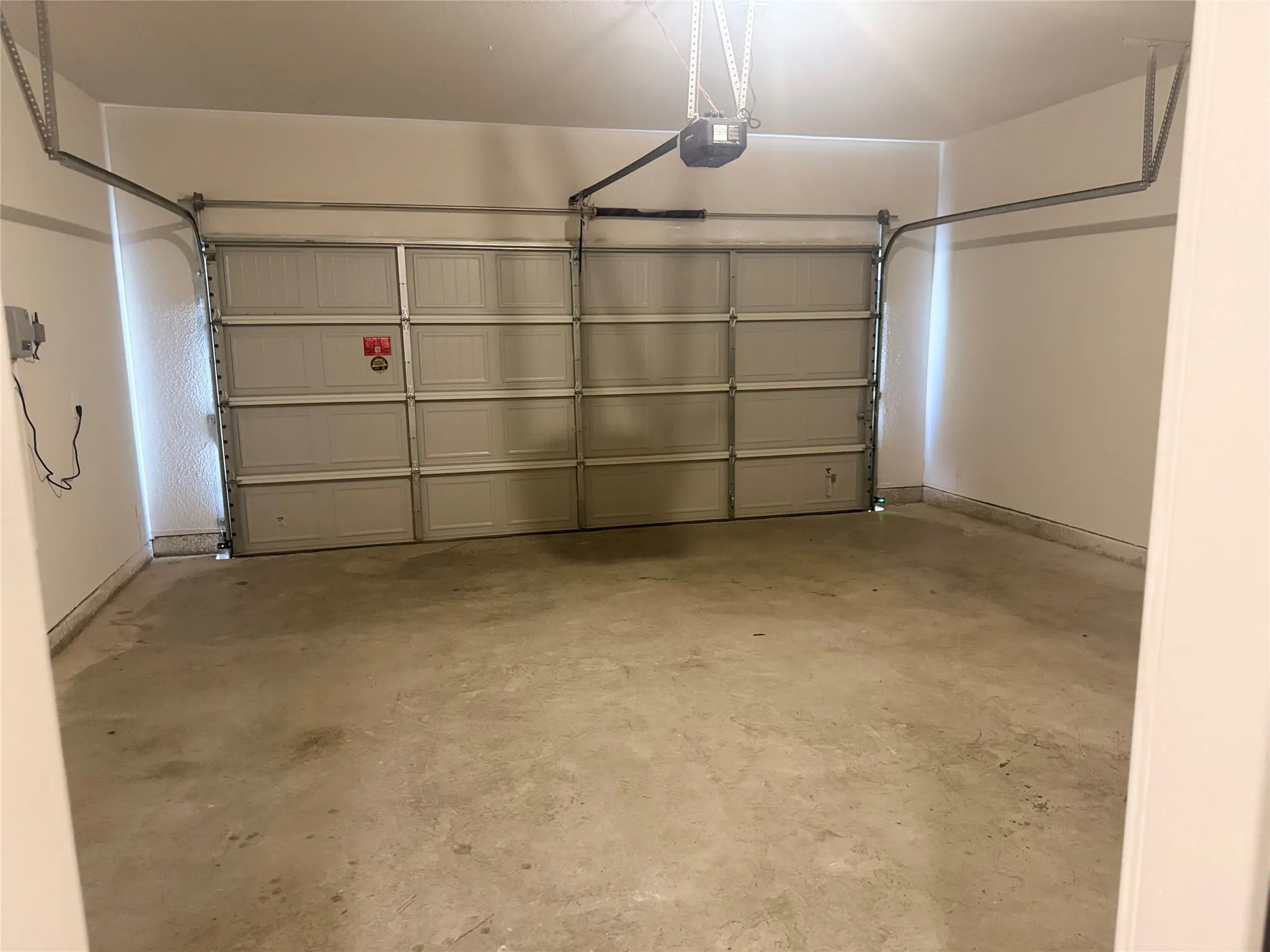 Attached garage with concrete flooring and overhead lighting