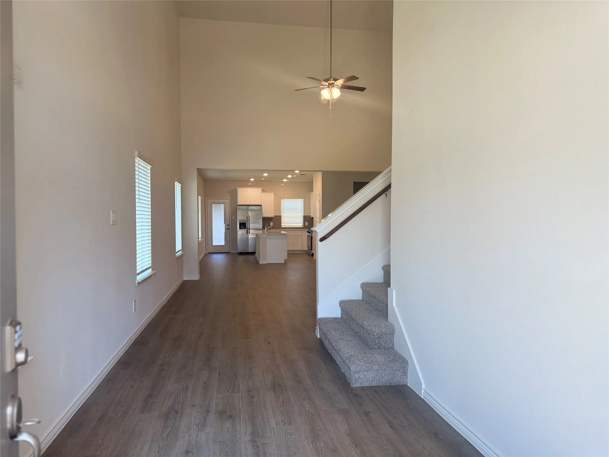 Inviting entryway showcasing the open-concept layout, with a clear view from the front door through the kitchen and toward the backyard.