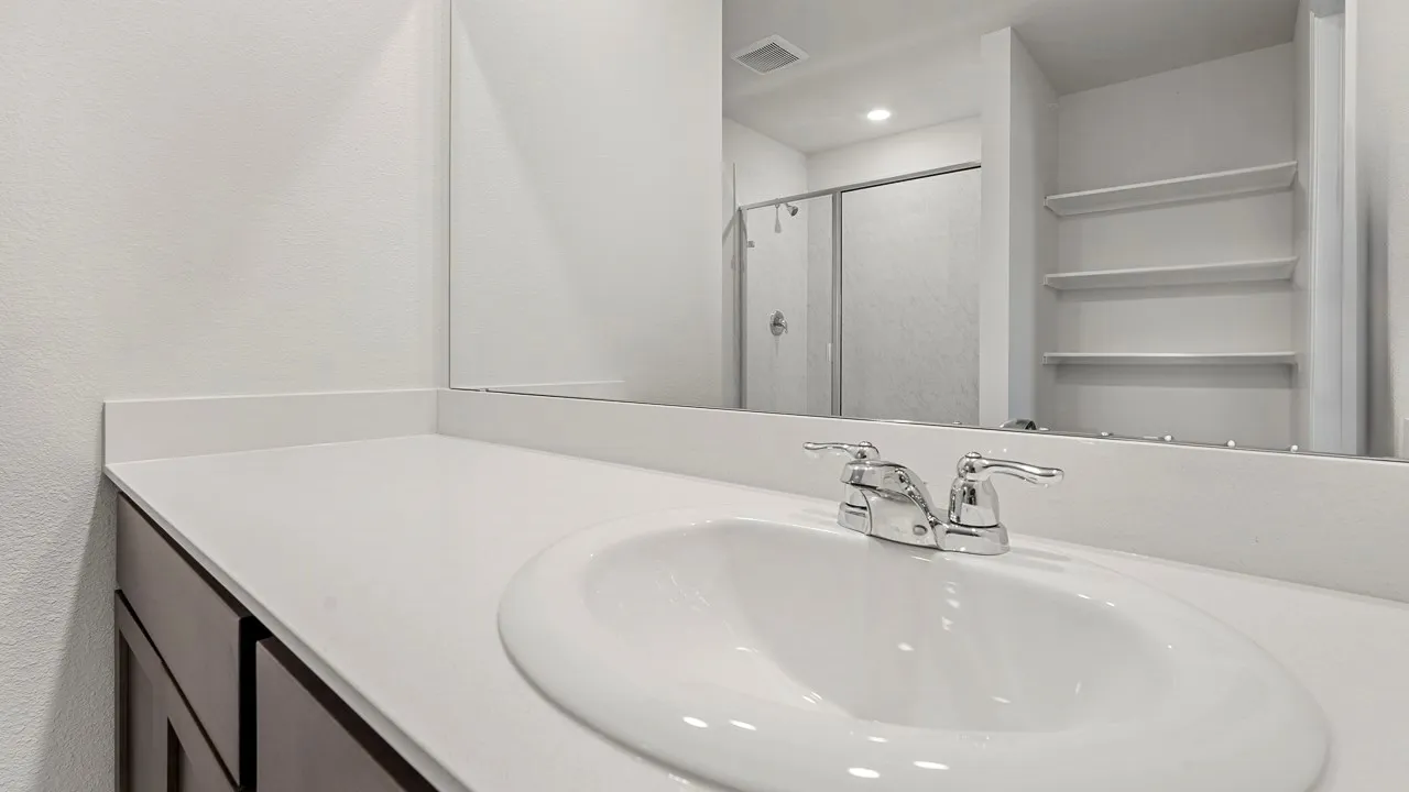White countertop with an integrated sink and chrome faucet