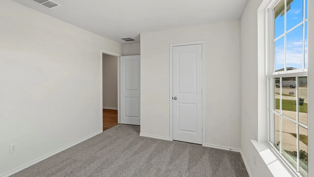 Neutral wall color with gray carpeting