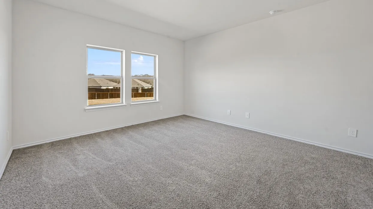 Spacious room with light gray carpet flooring and neutral wall paint