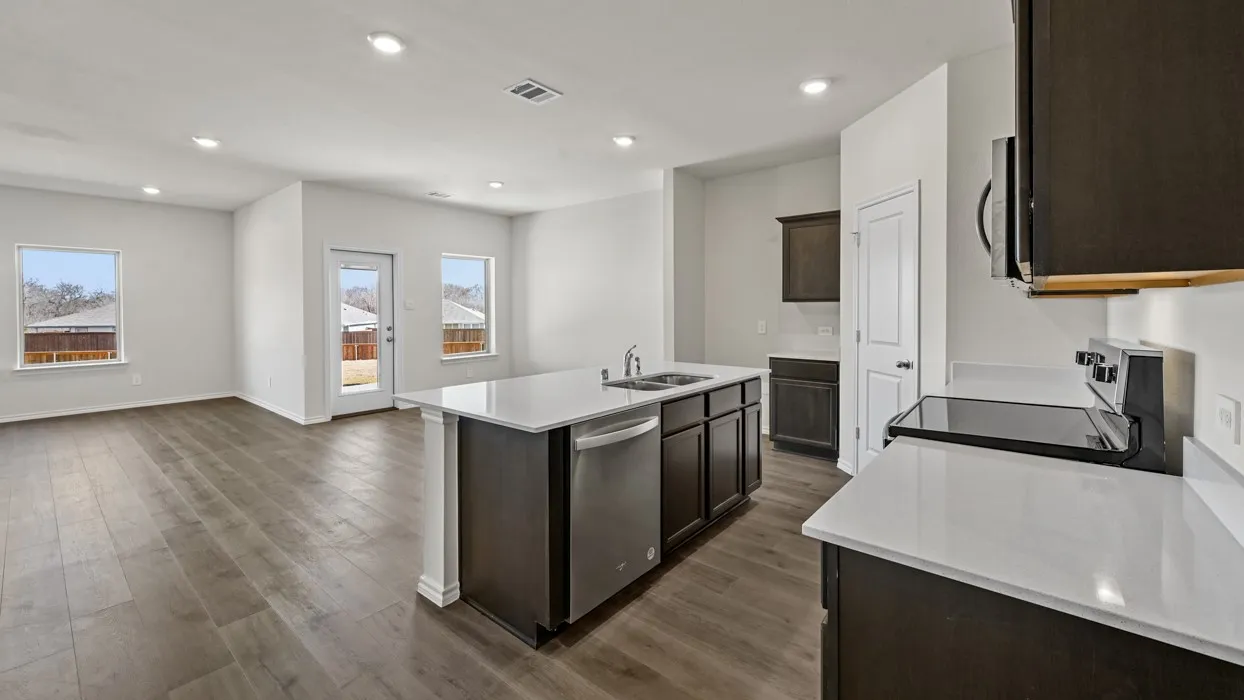 Open-concept living area featuring wood-finish flooring, recessed lighting, and white walls