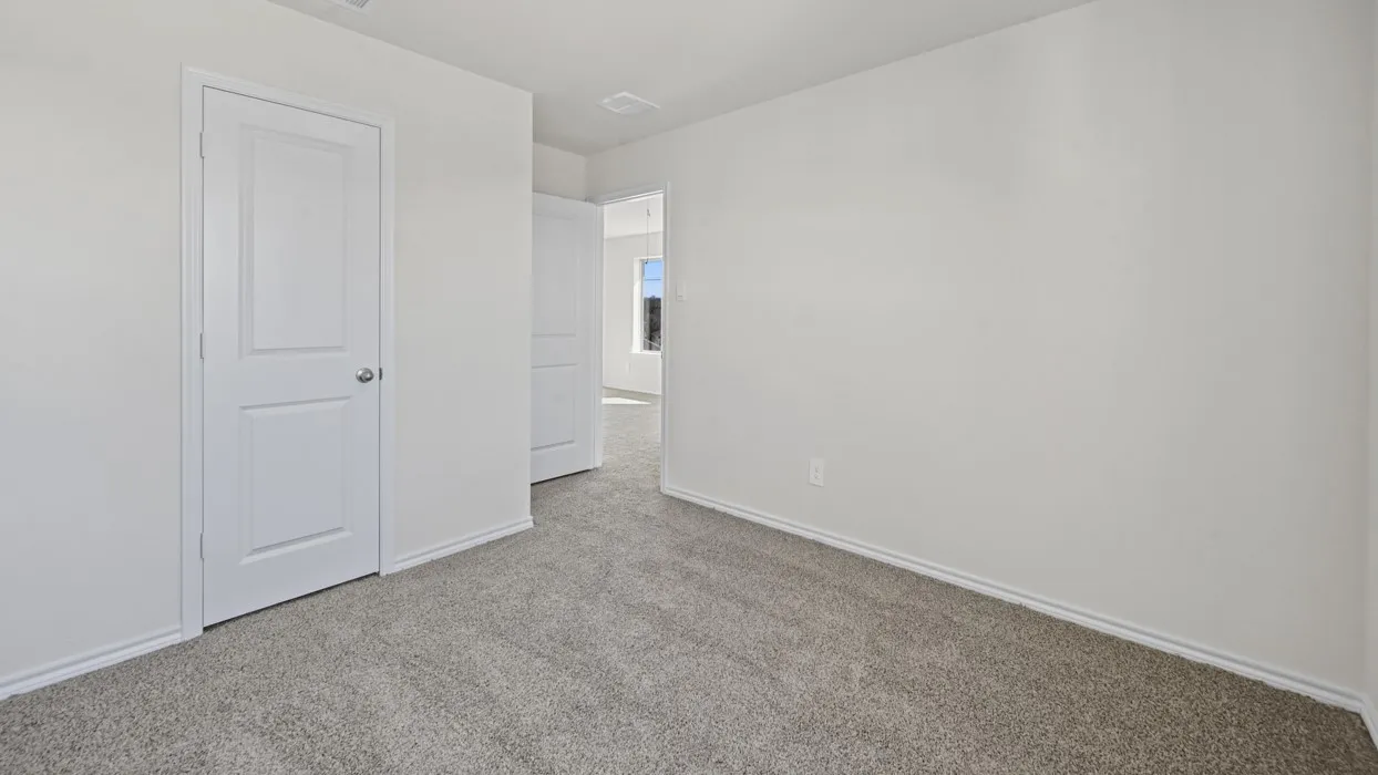 Neutral tone walls and light gray carpet create a versatile interior