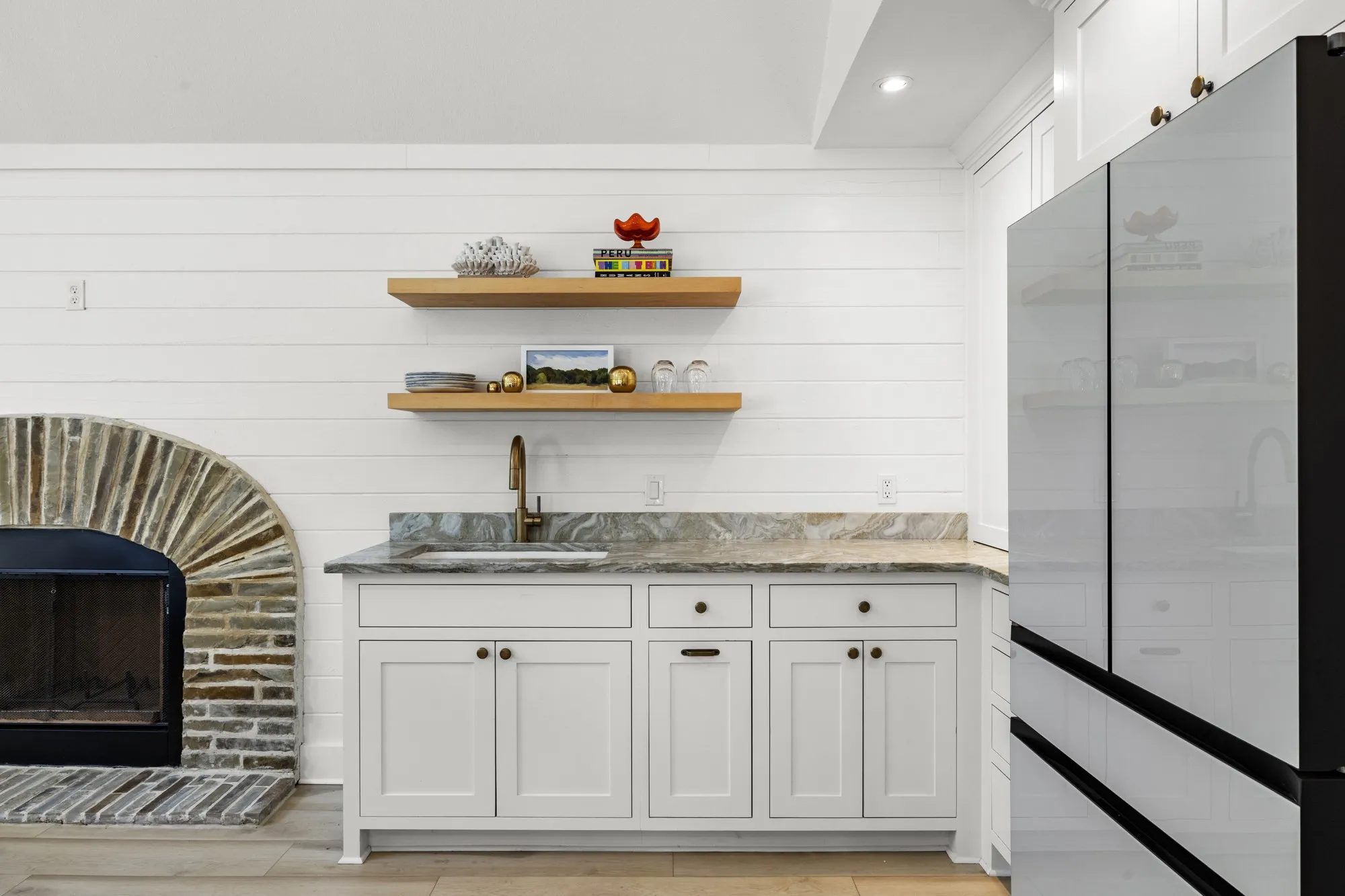 Bar with white cabinets, open shelves, freestanding refrigerator, light stone counters, and light wood-type flooring
