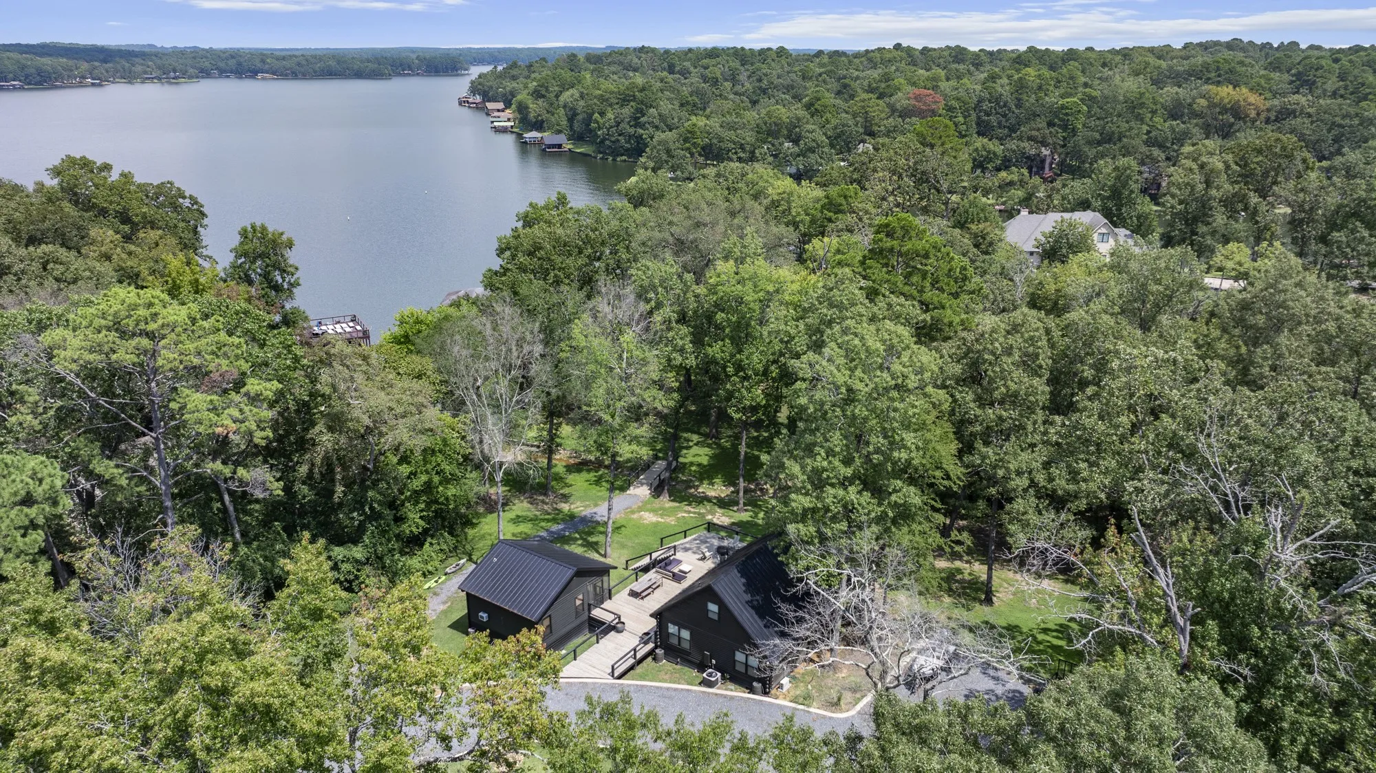 Aerial view of a heavily wooded area and a nearby body of water