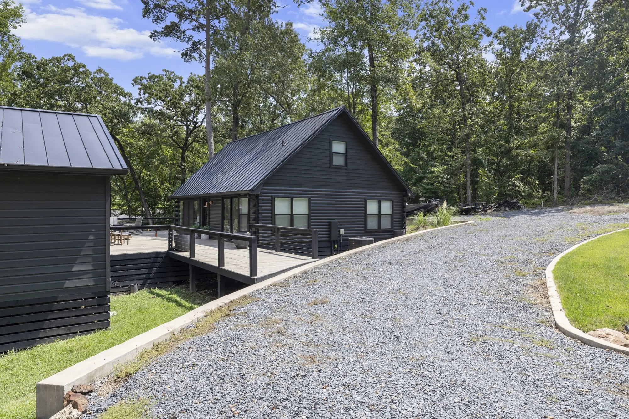 Back of house with a wooden deck, a metal roof, and a standing seam roof