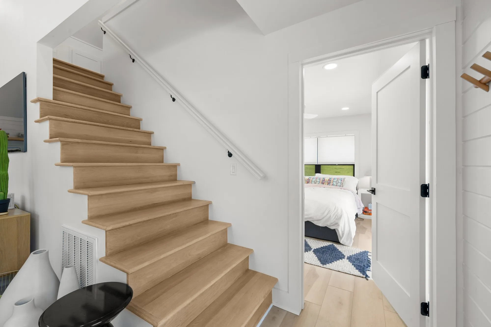 Stairway featuring wood finished floors and recessed lighting